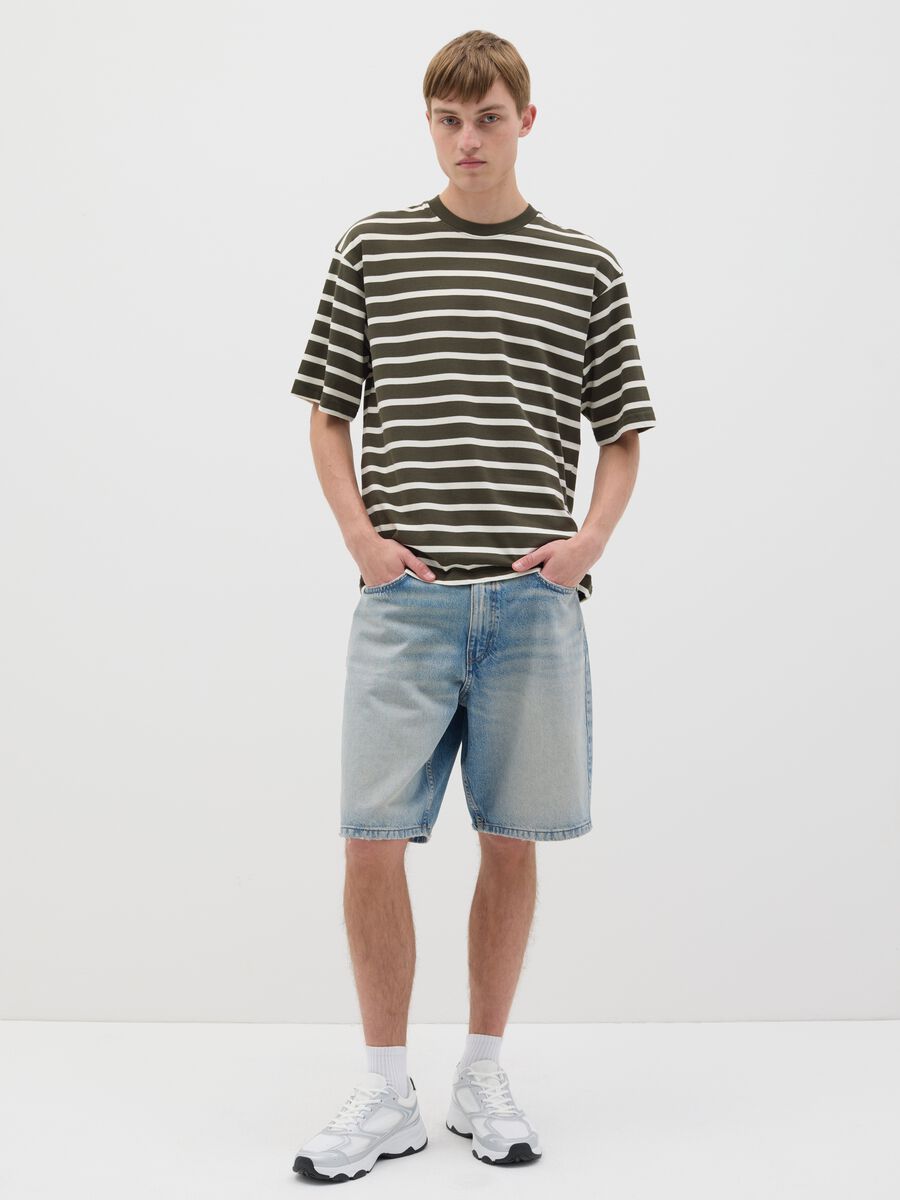 Blue denim shorts with ripped details_0