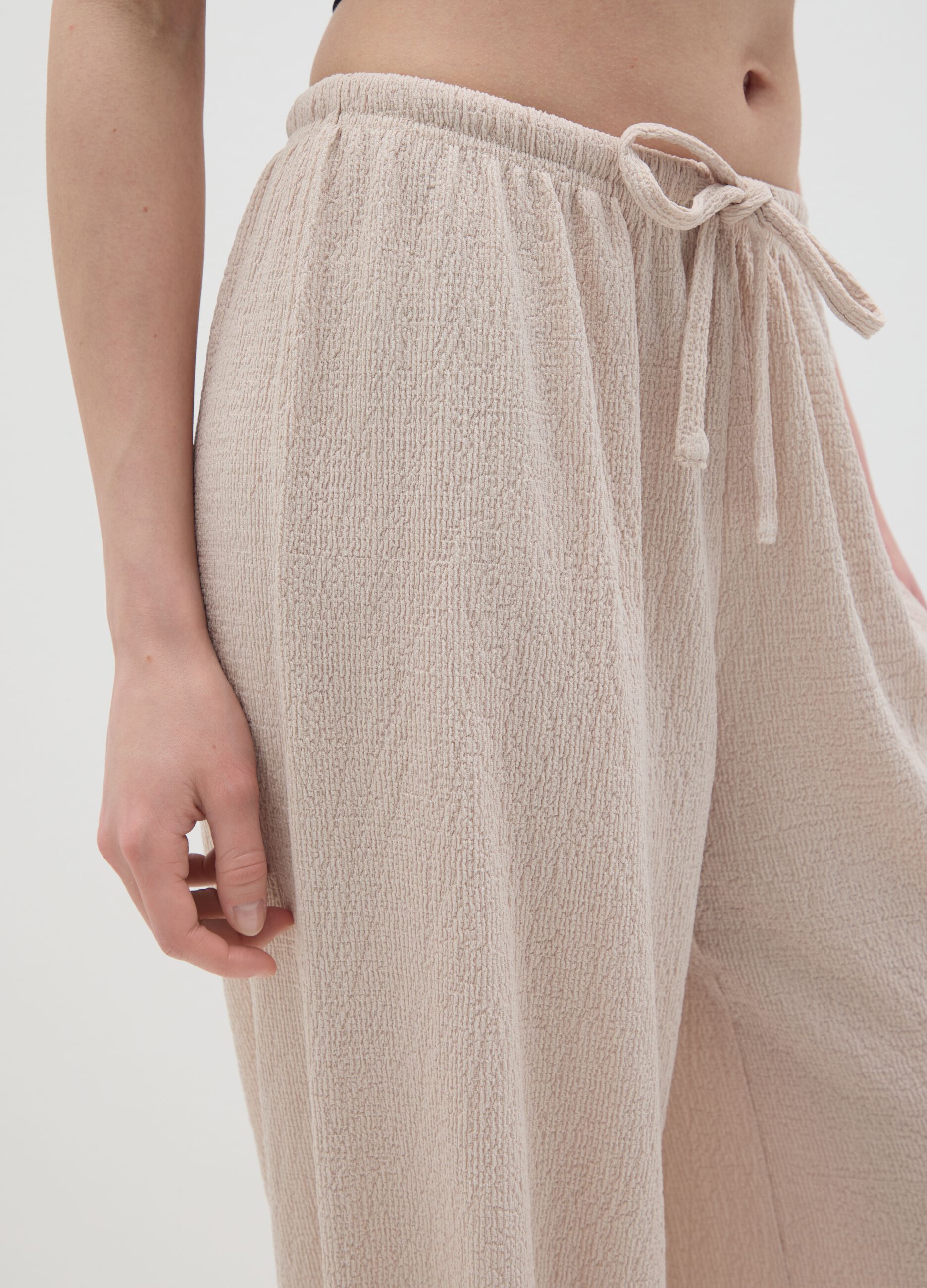 Women's beige regular-fit palazzo pants in stretch fabric.