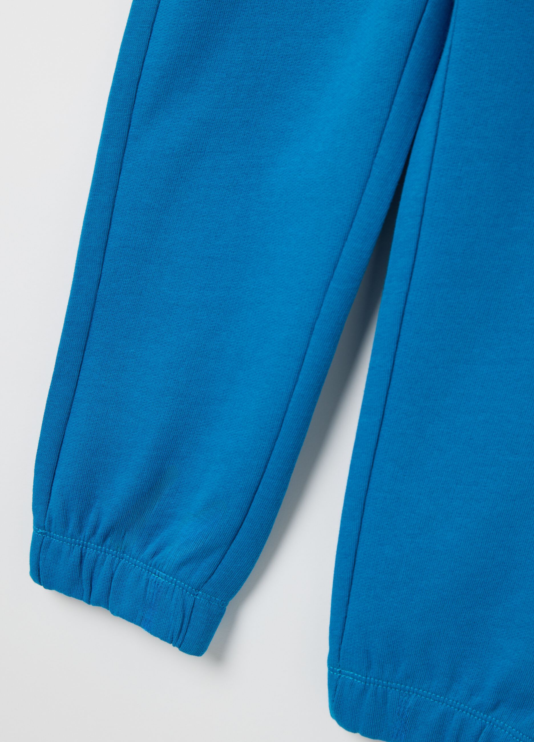 Light blue cotton joggers with drawstring and print