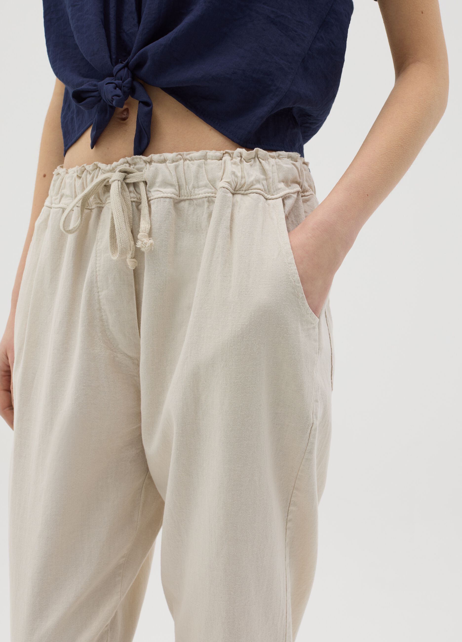 Beige trousers with drawstring and broderie anglaise details