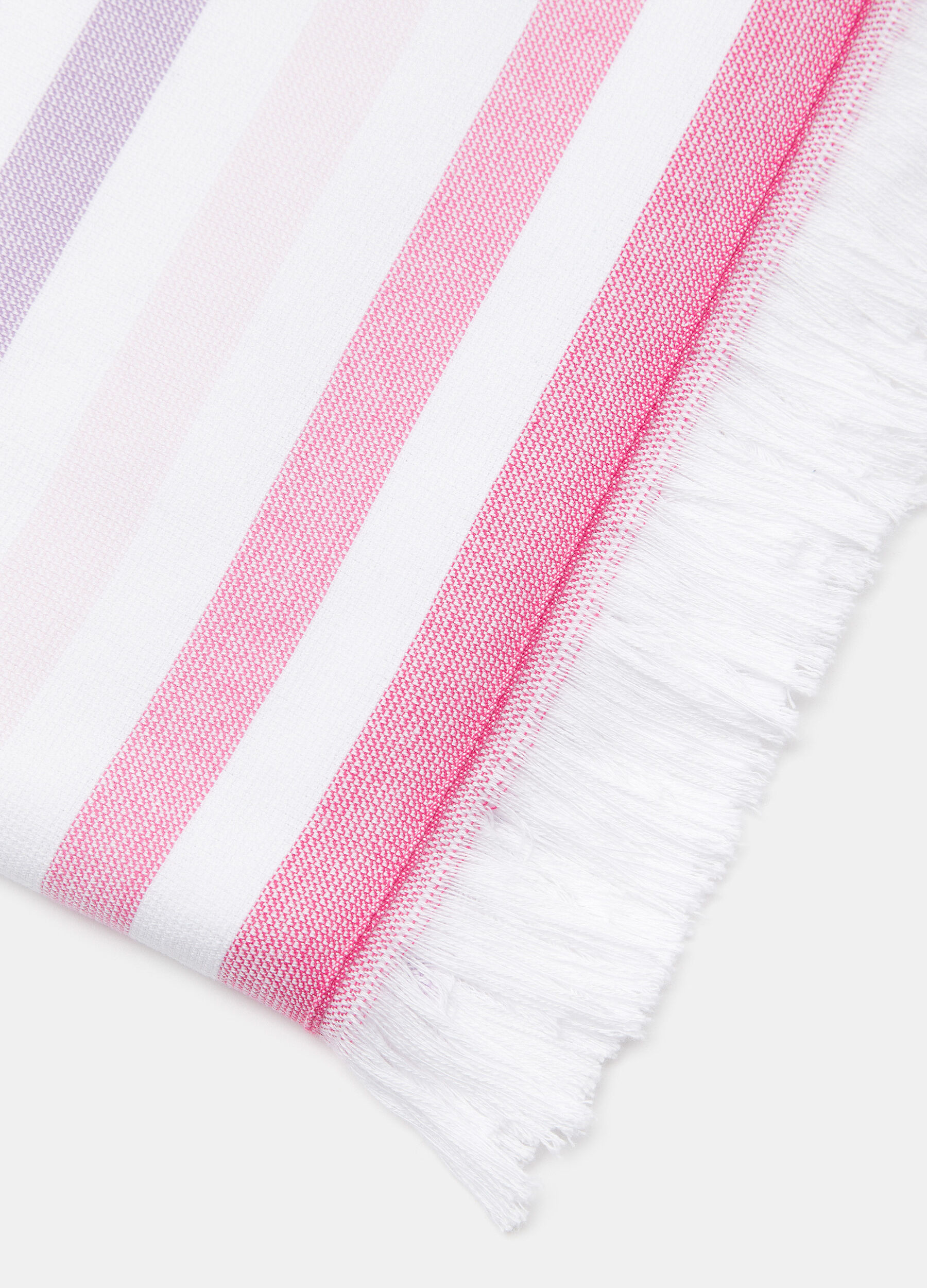 100% cotton beach towel with fringed trim.