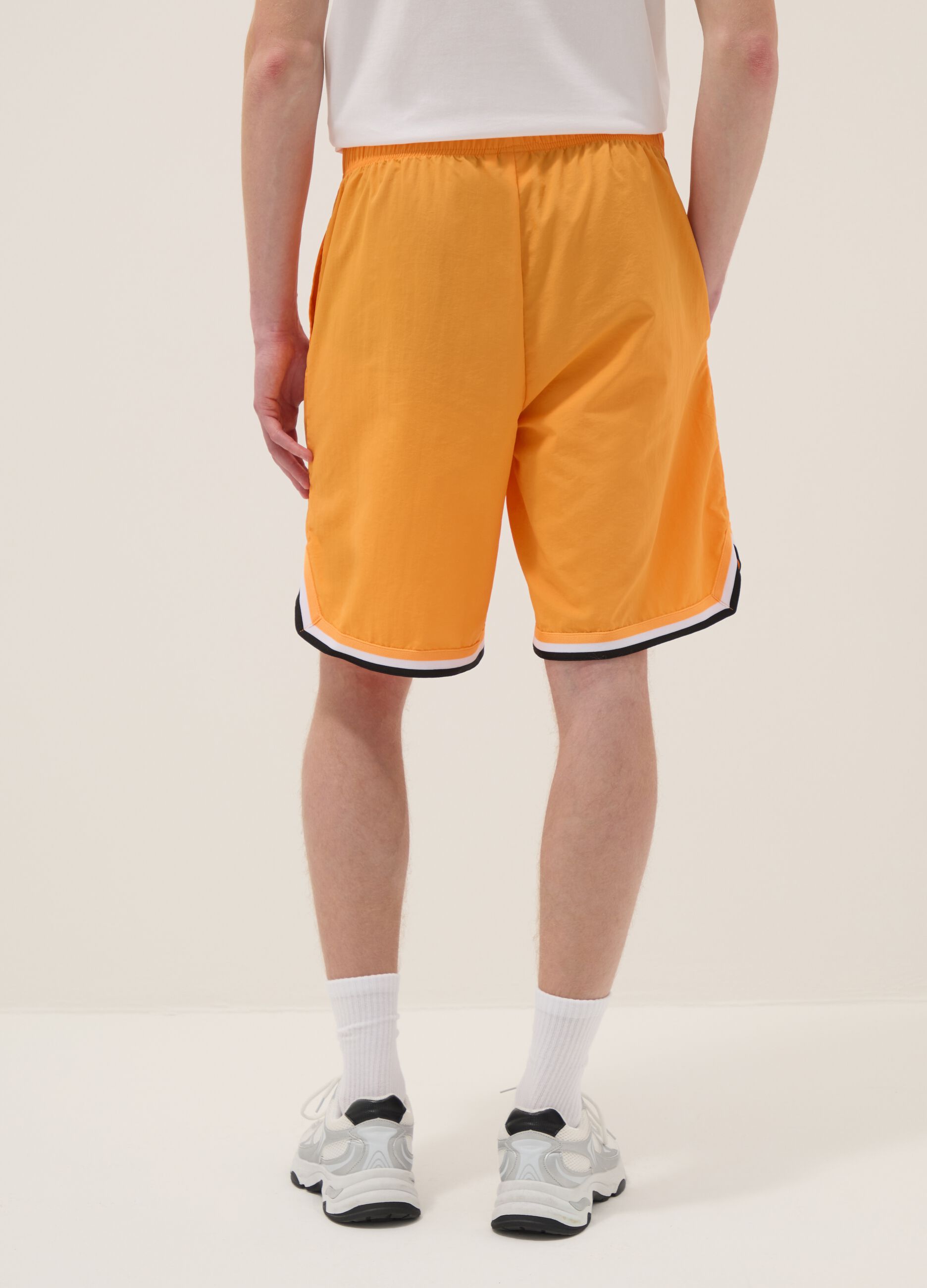 Orange regular fit sports shorts with white and black details