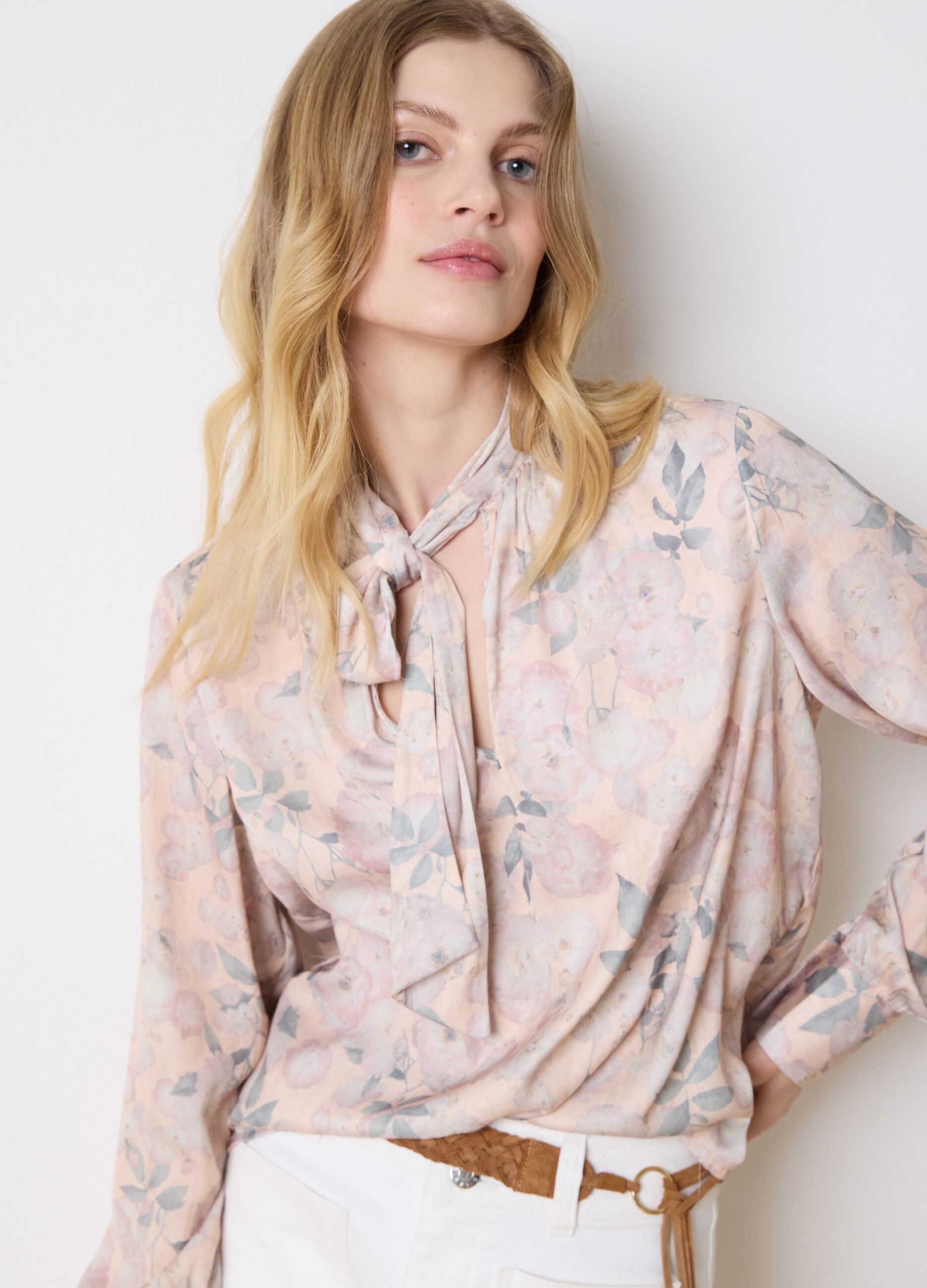 Beige blouse with floral pattern and bow