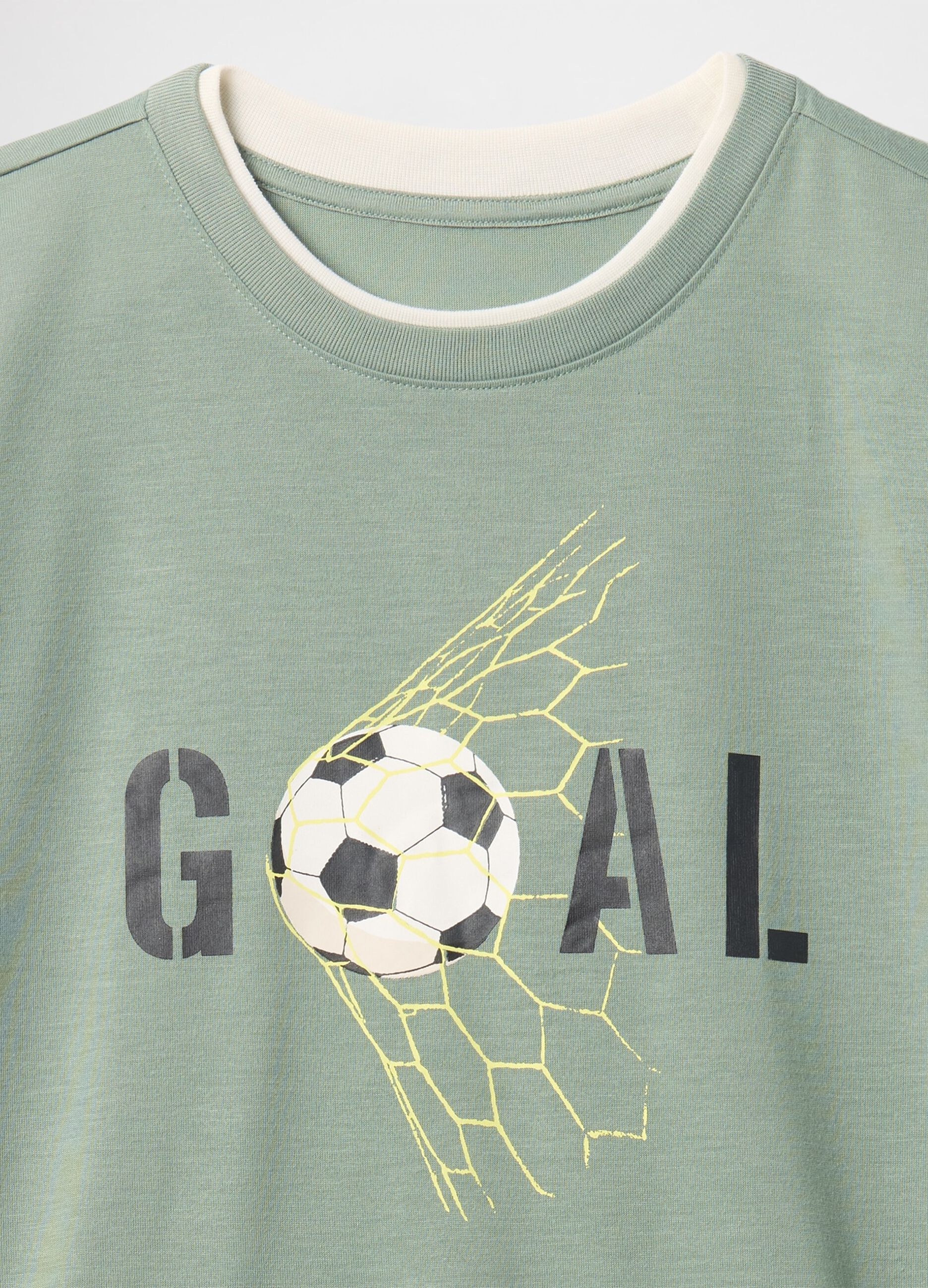 Green kids' pyjamas with football theme