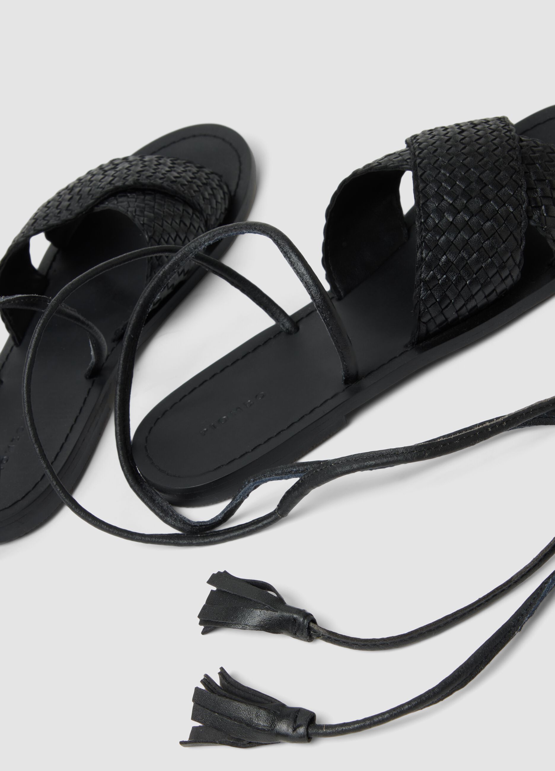 Black woven sandals with ankle ties