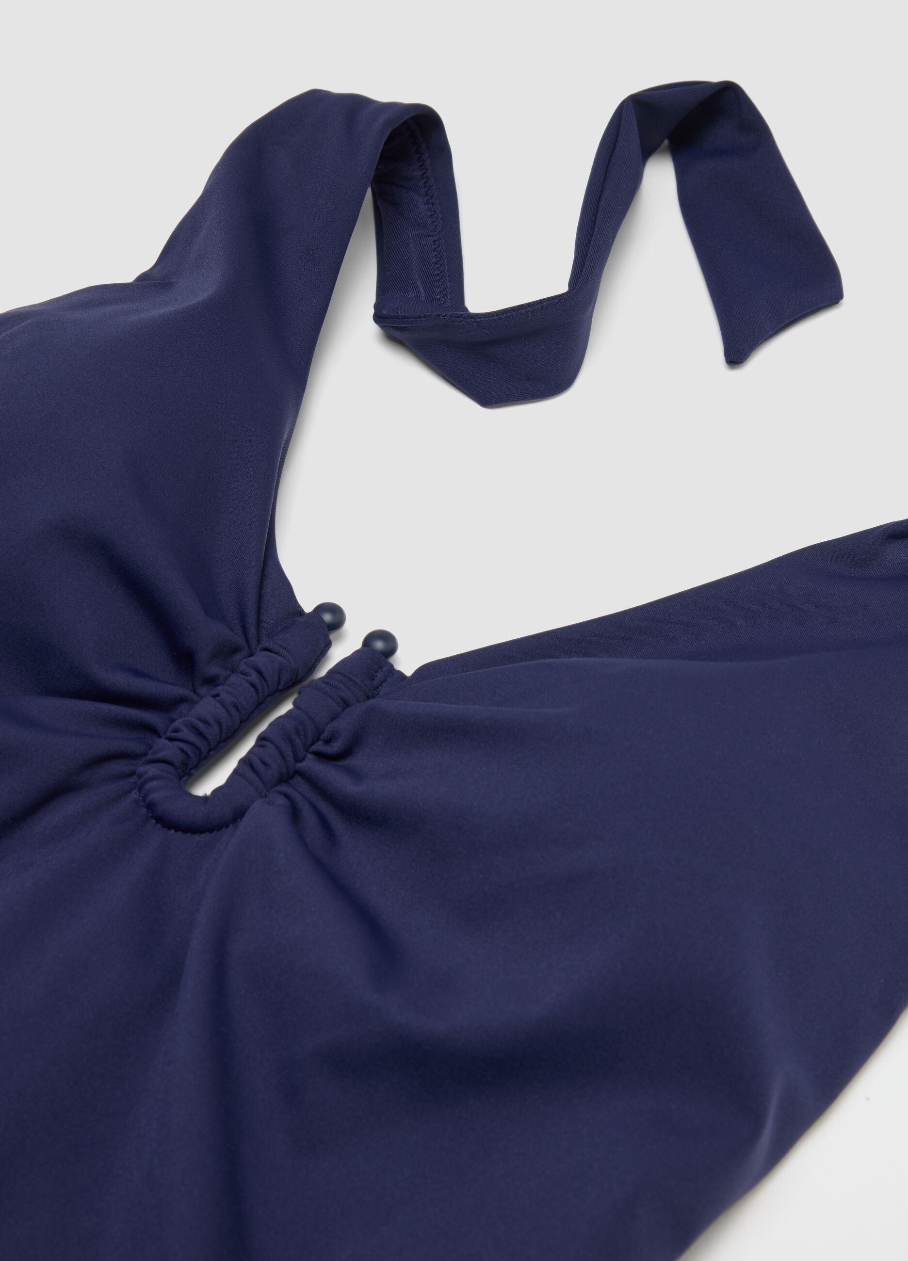 Blue stretch fabric swimsuit with halterneck ties