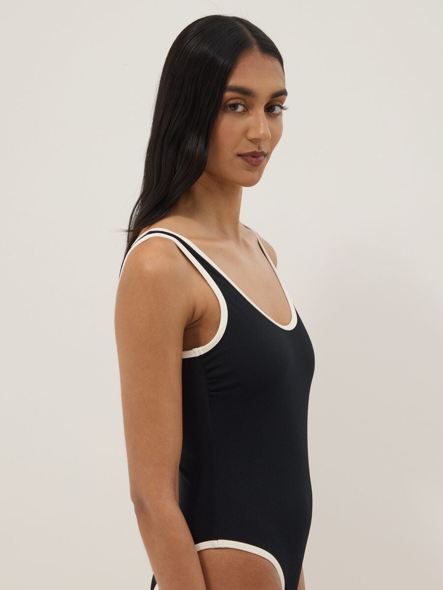Black stretch one-piece swimsuit with white trim_2