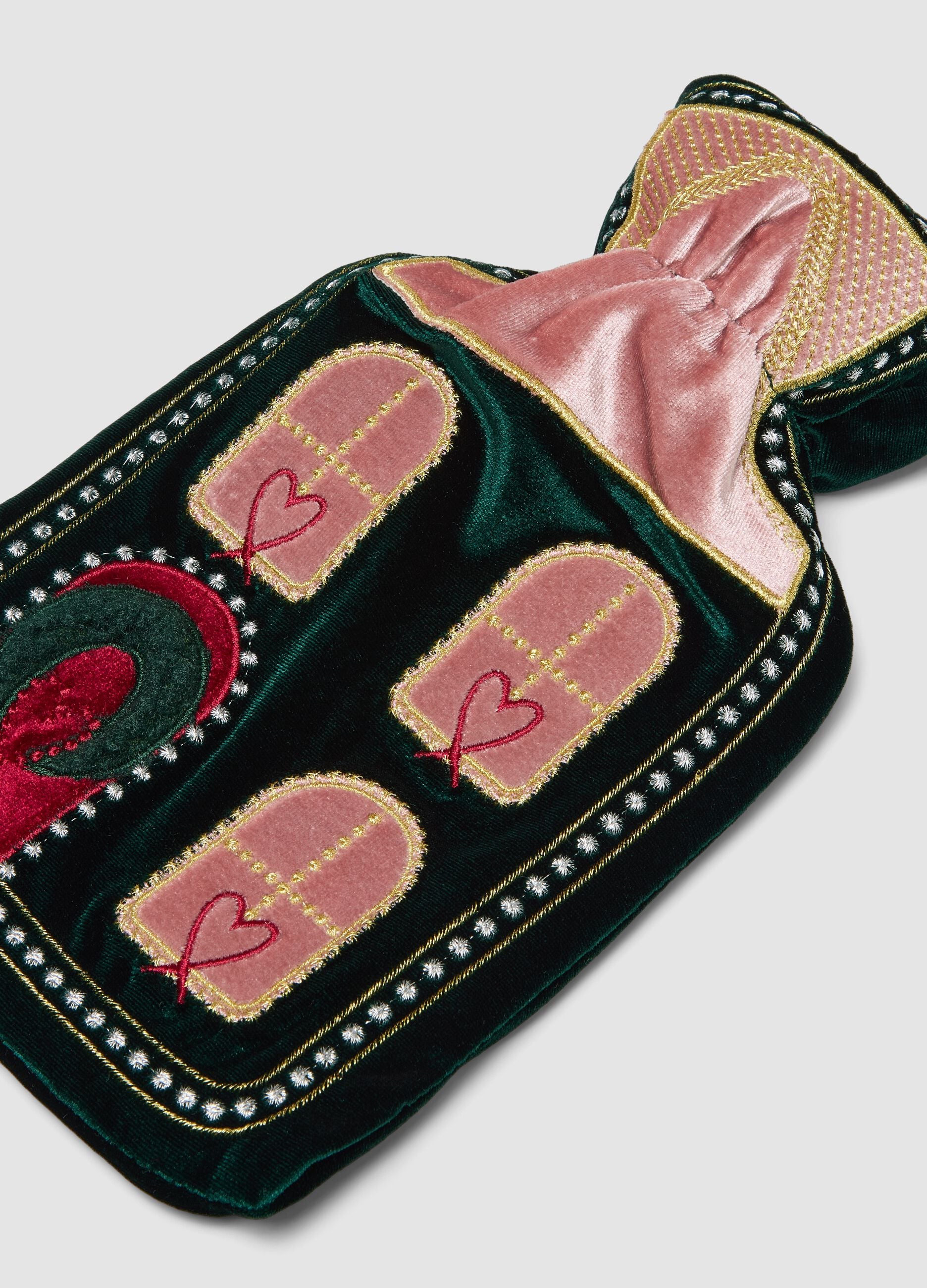 Green and pink hot water bottle with decorative embroidery