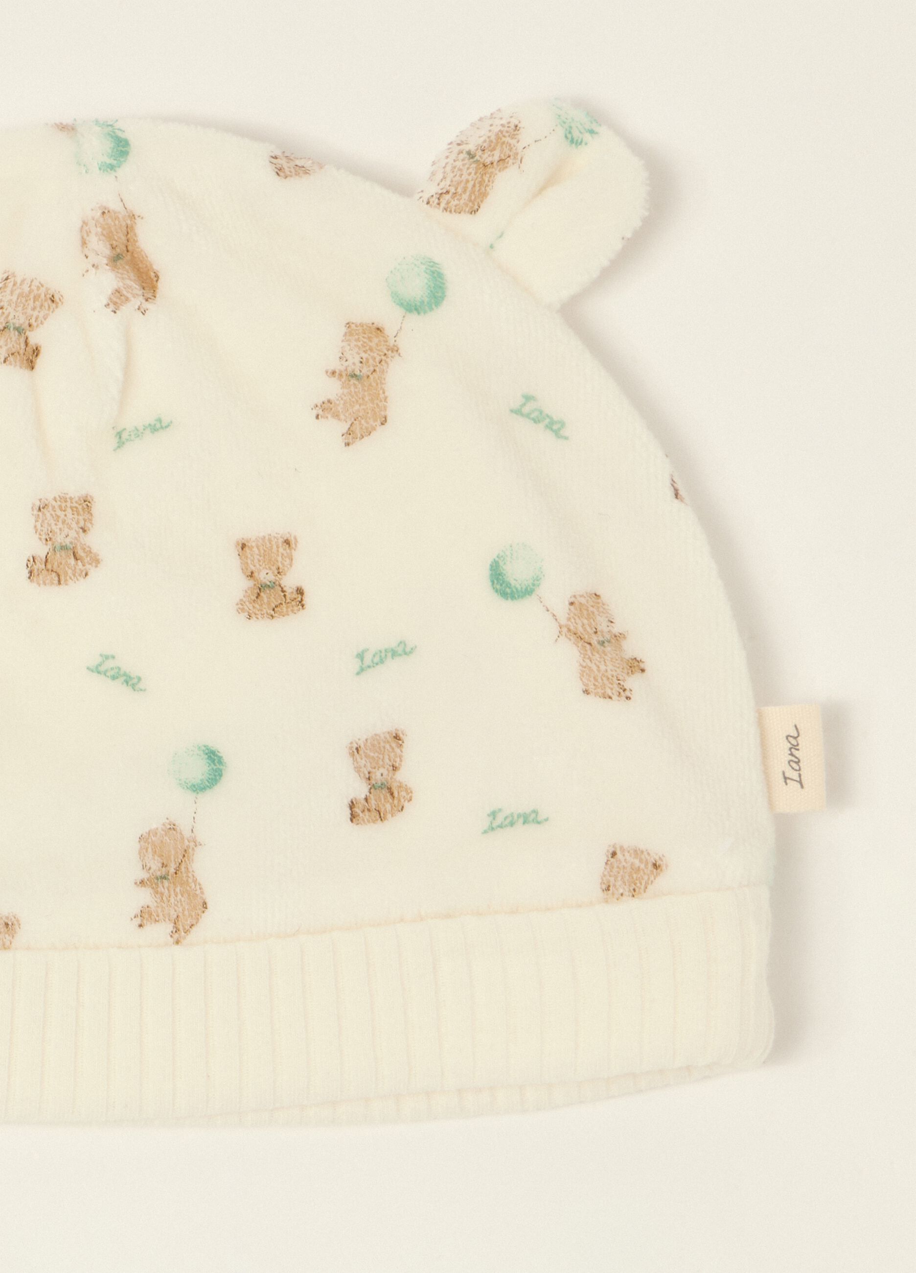 White baby sleepsuit with teddy bear print