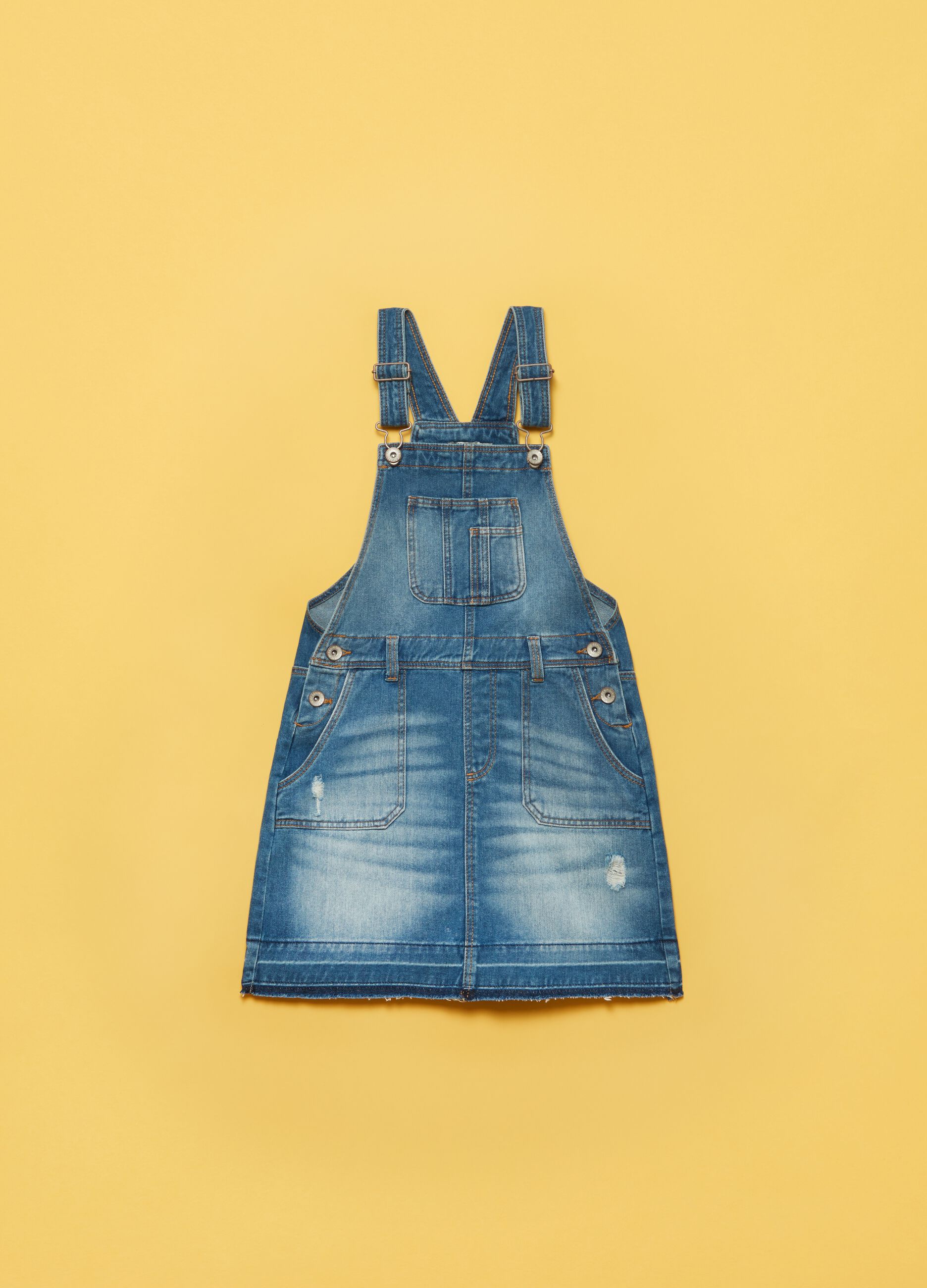 Denim dungarees with raw edging