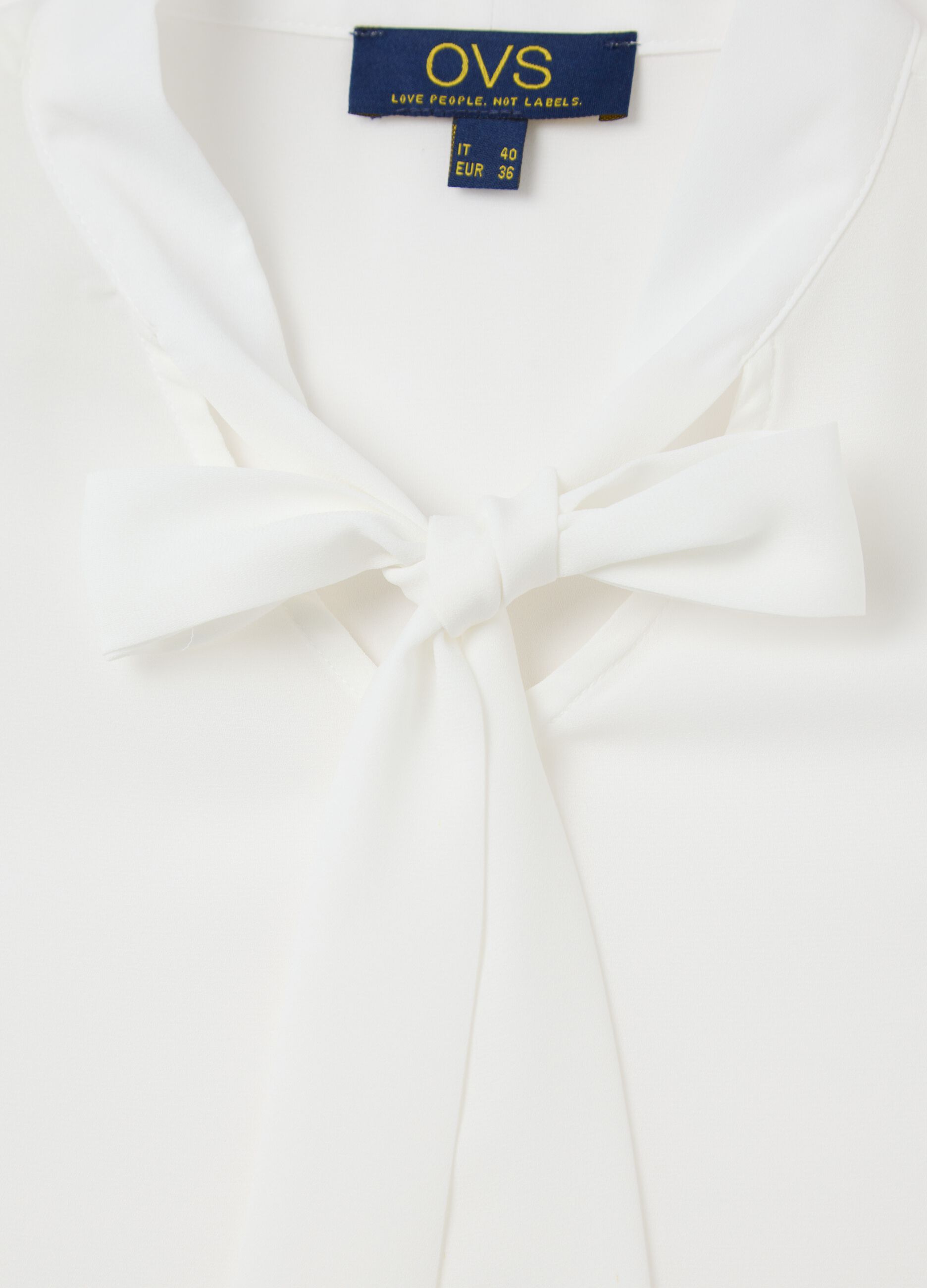 White sleeveless blouse with flounce