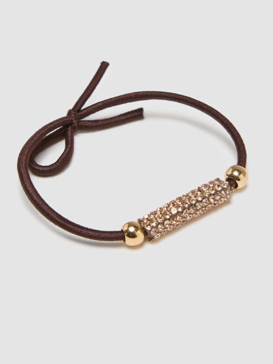Accessorio per capelli marrone con elementi dorati_1