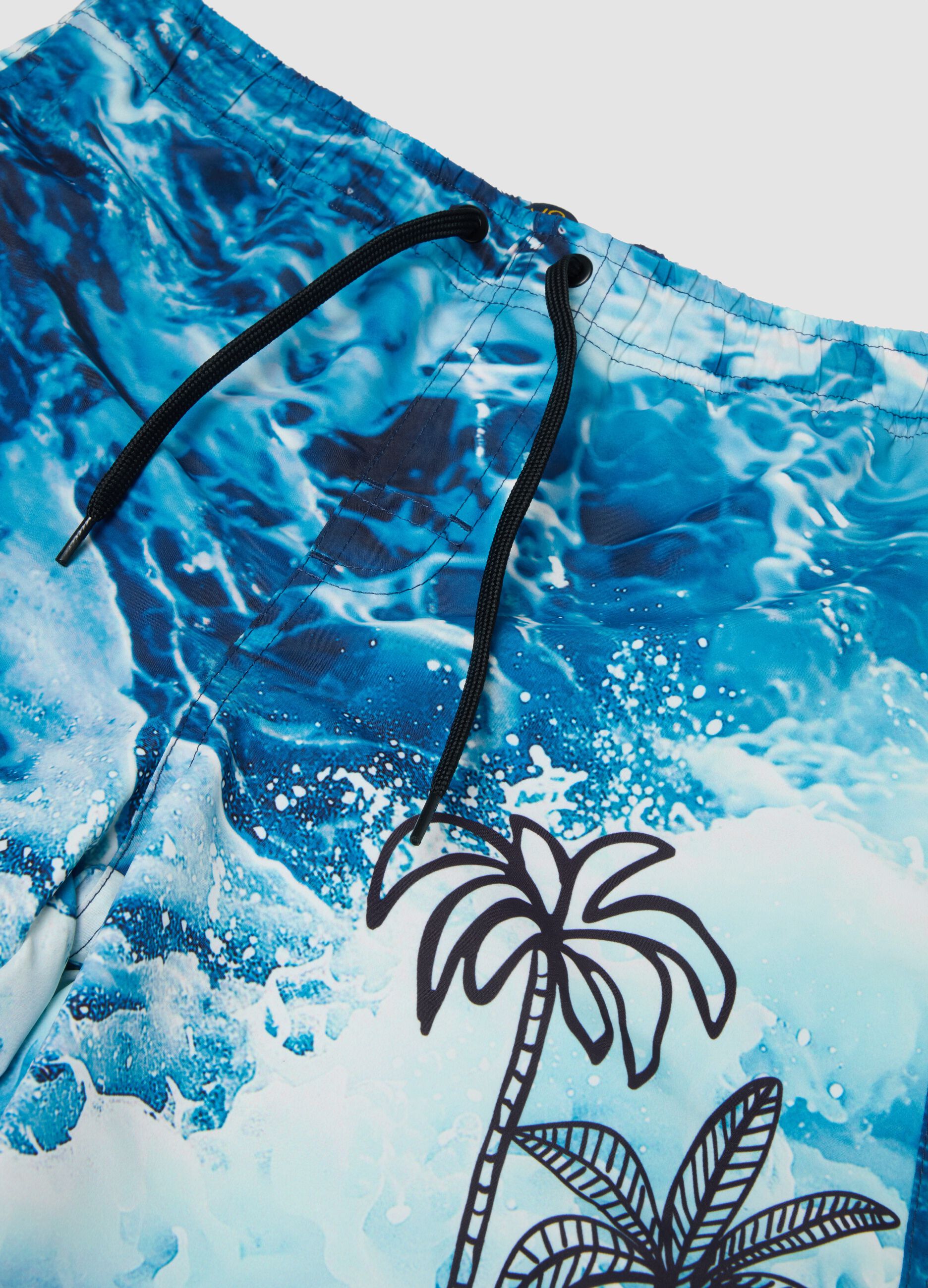 Blue boys&rsquo; swim shorts with wave and palm print