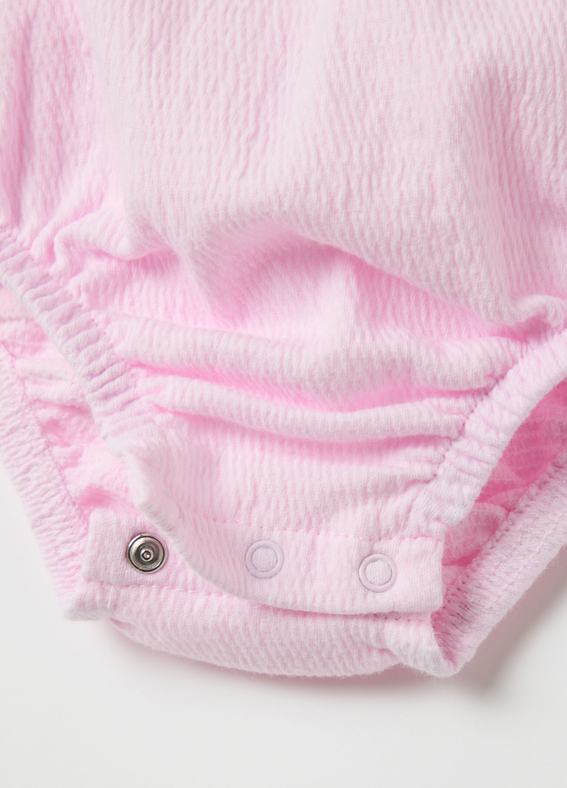 Pink sleeveless bodysuit with flounce