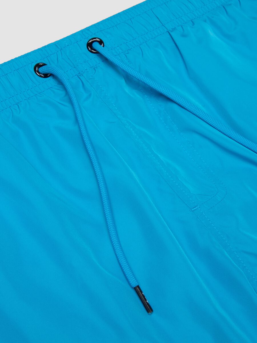 Blue swim shorts with elasticated waist and drawstring_1