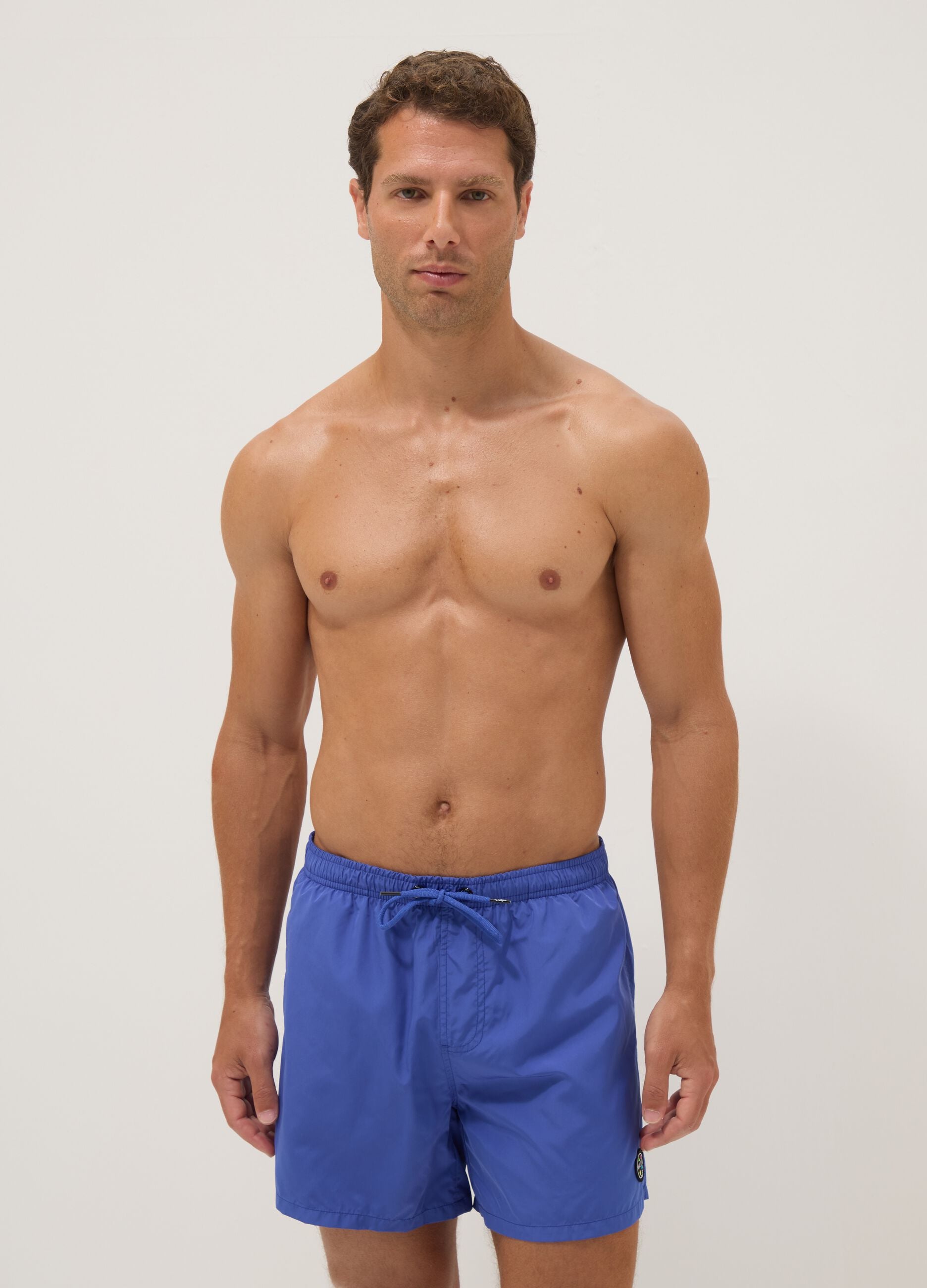 Blue swim shorts with elasticated waistband and drawstring