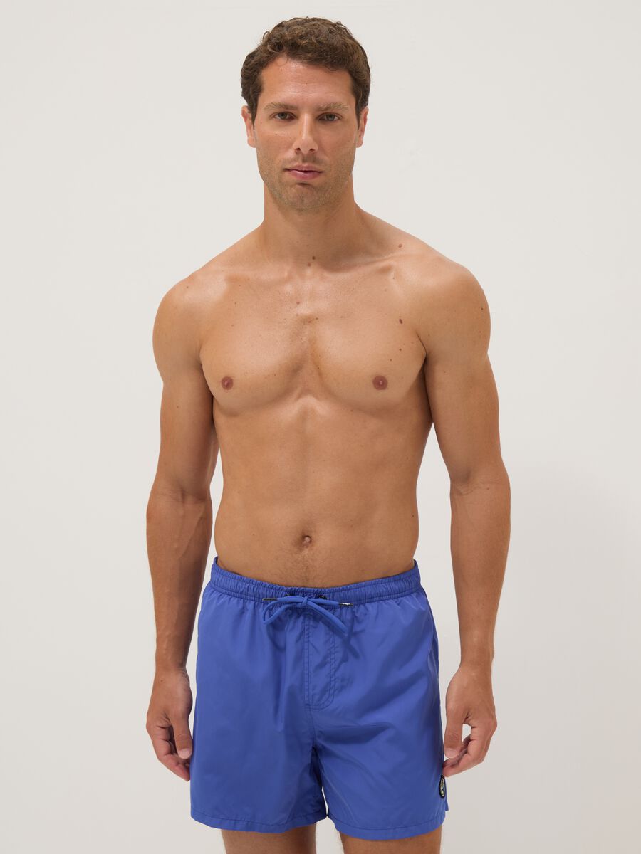 Blue swim shorts with elasticated waistband and drawstring_1