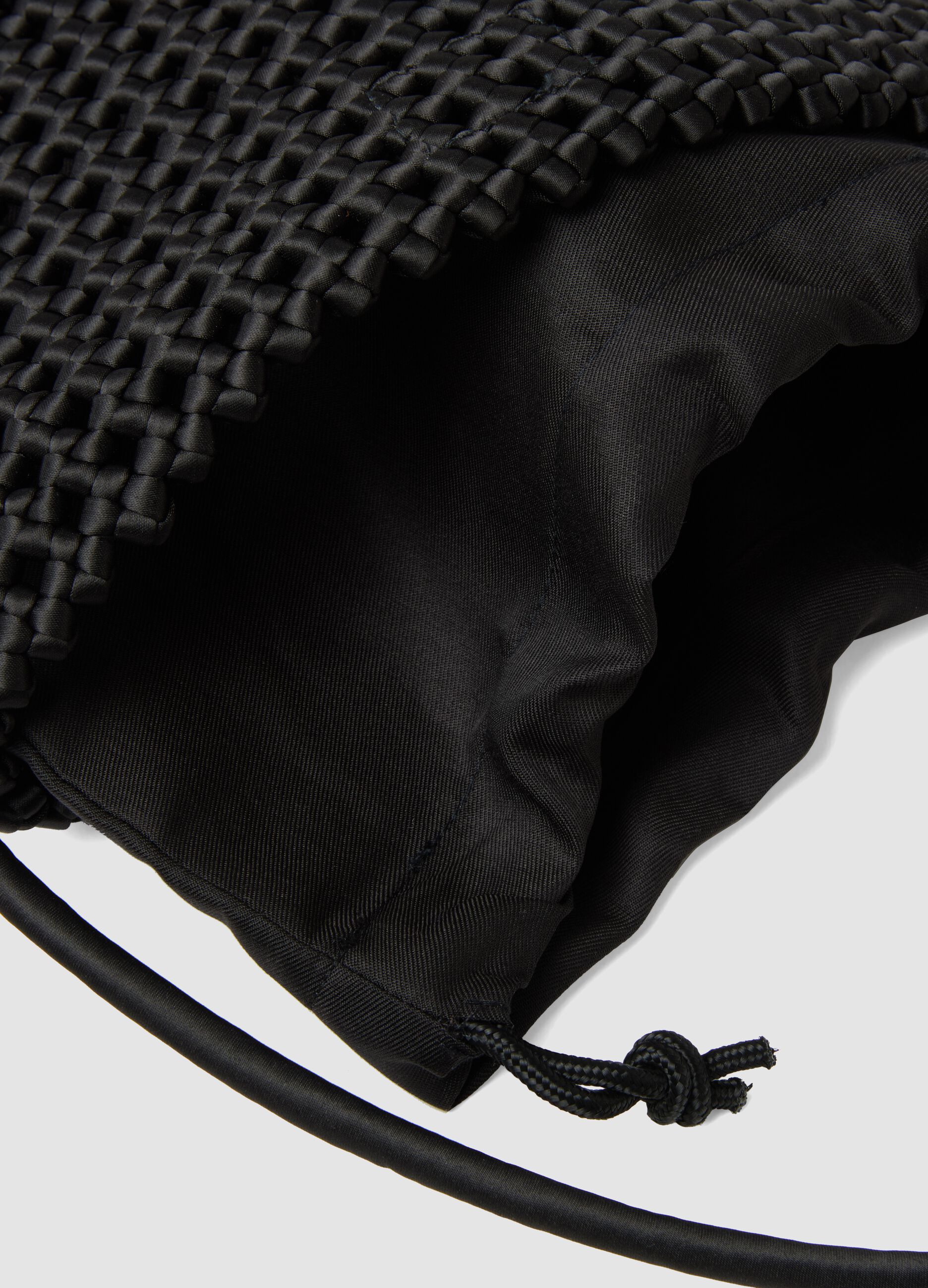 Black woven bag with adjustable shoulder strap