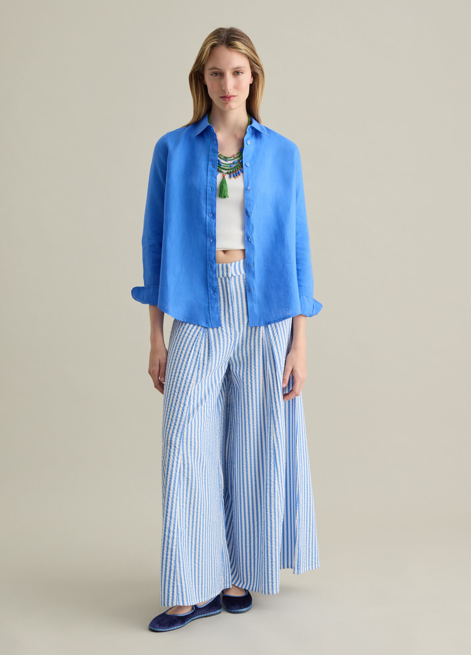 Blue flare-fit trousers in striped seersucker