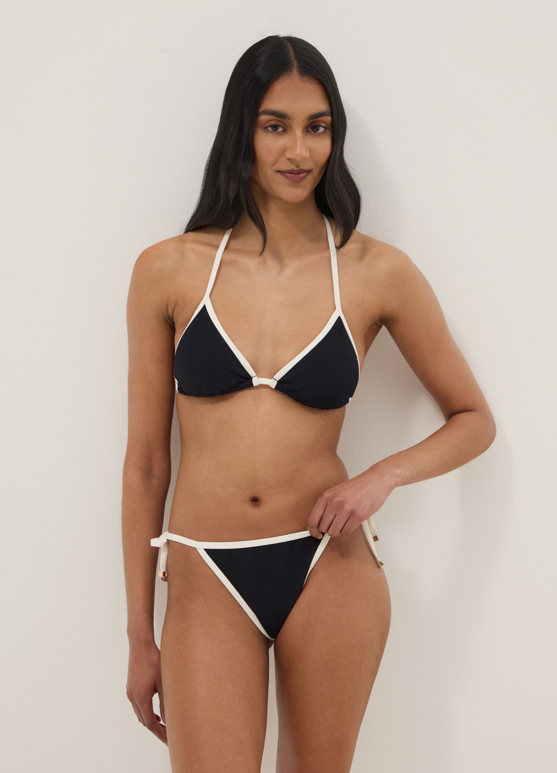 Black and white bikini bottoms in stretch fabric with side ties