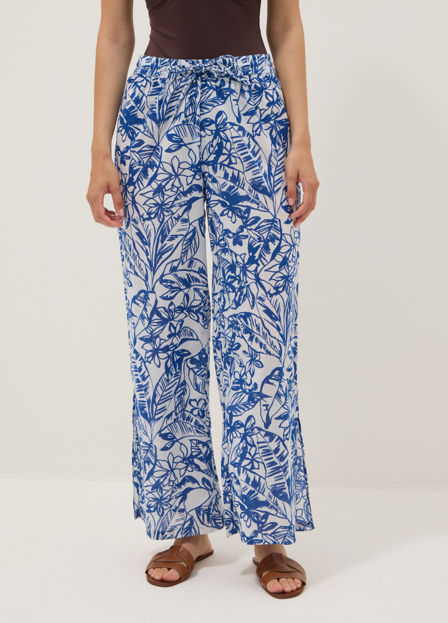 Blue and white organic cotton trousers with floral print