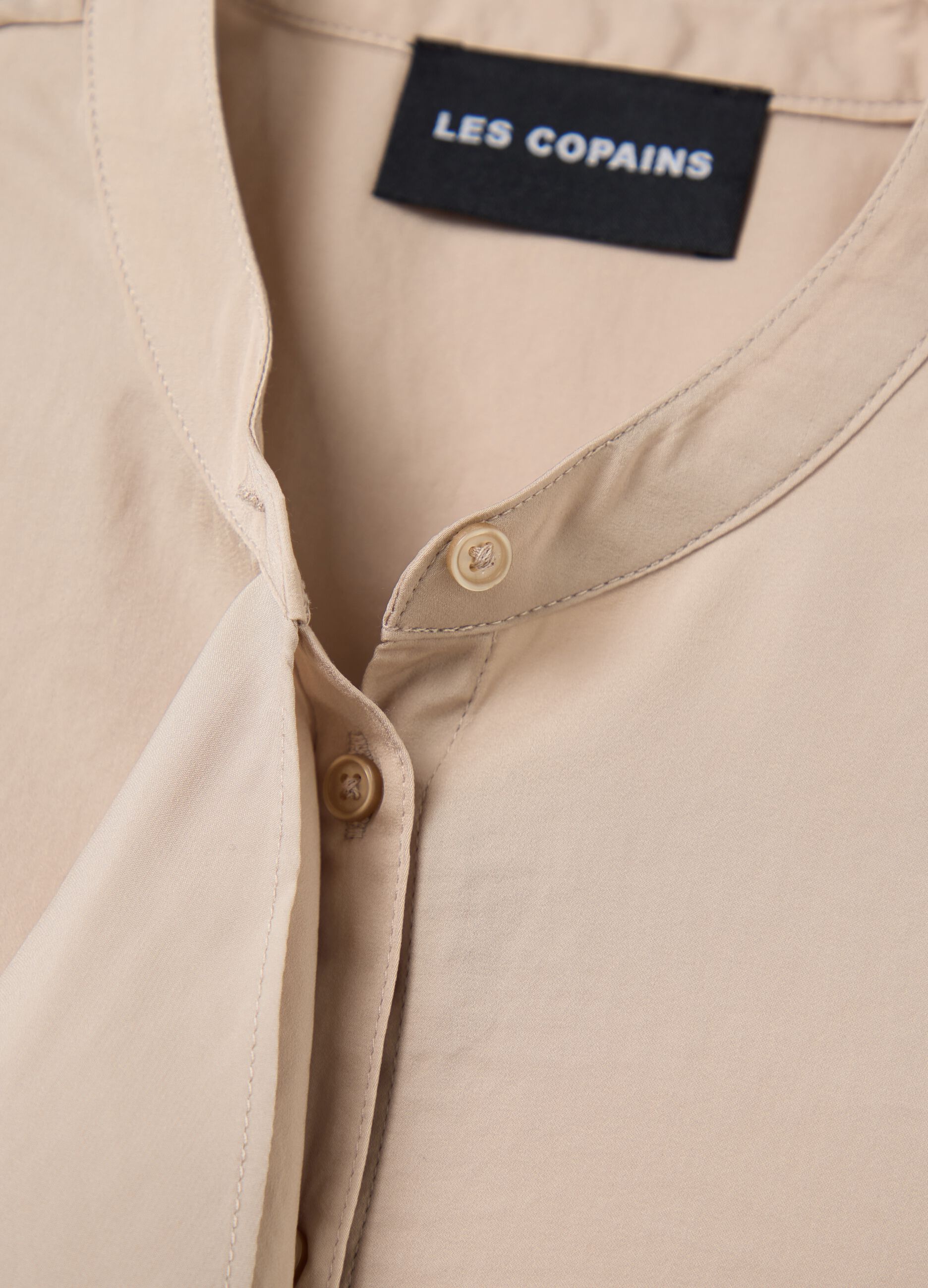 Beige sleeveless blouse with flounce
