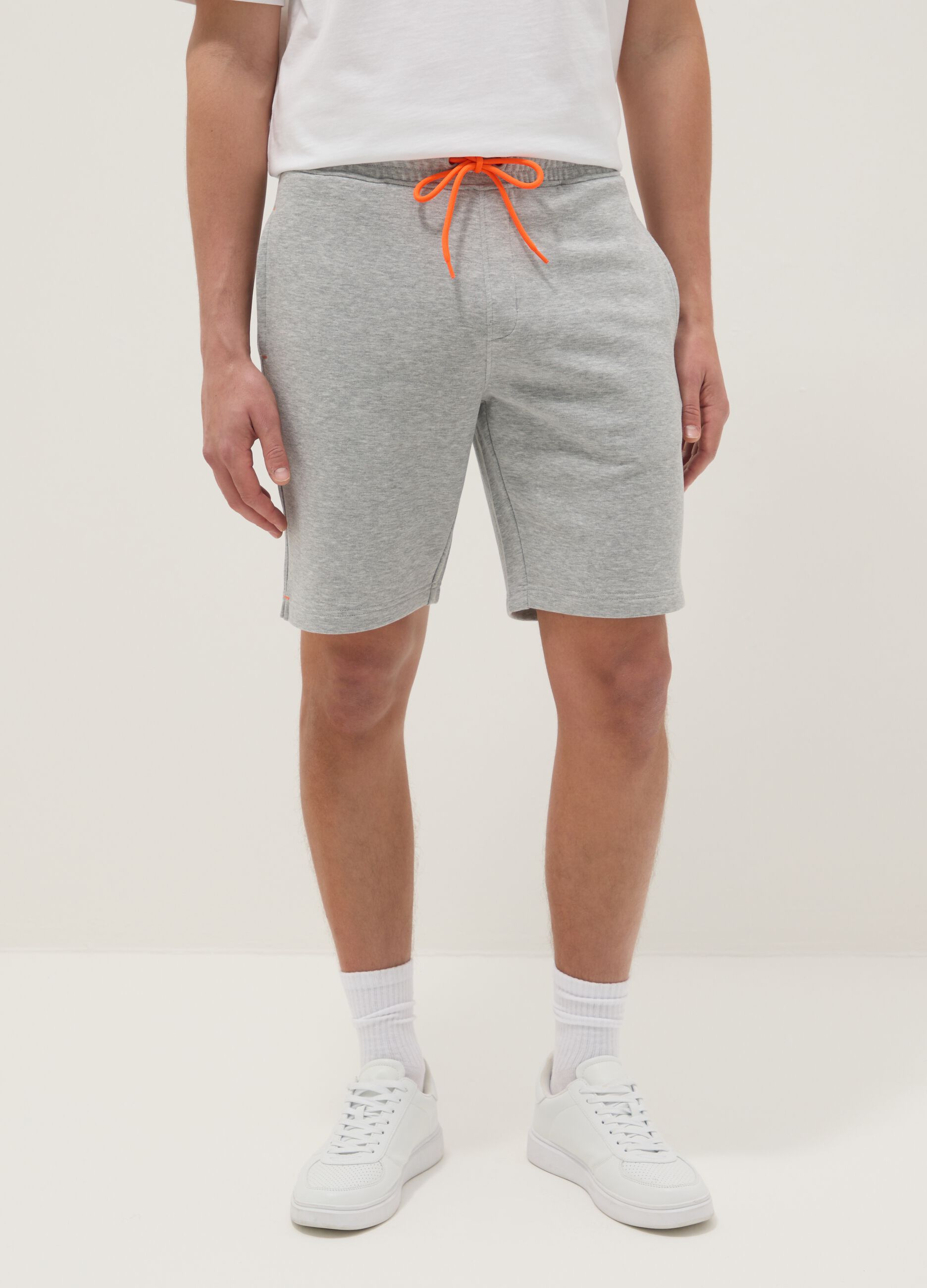 Grey shorts with orange drawstring
