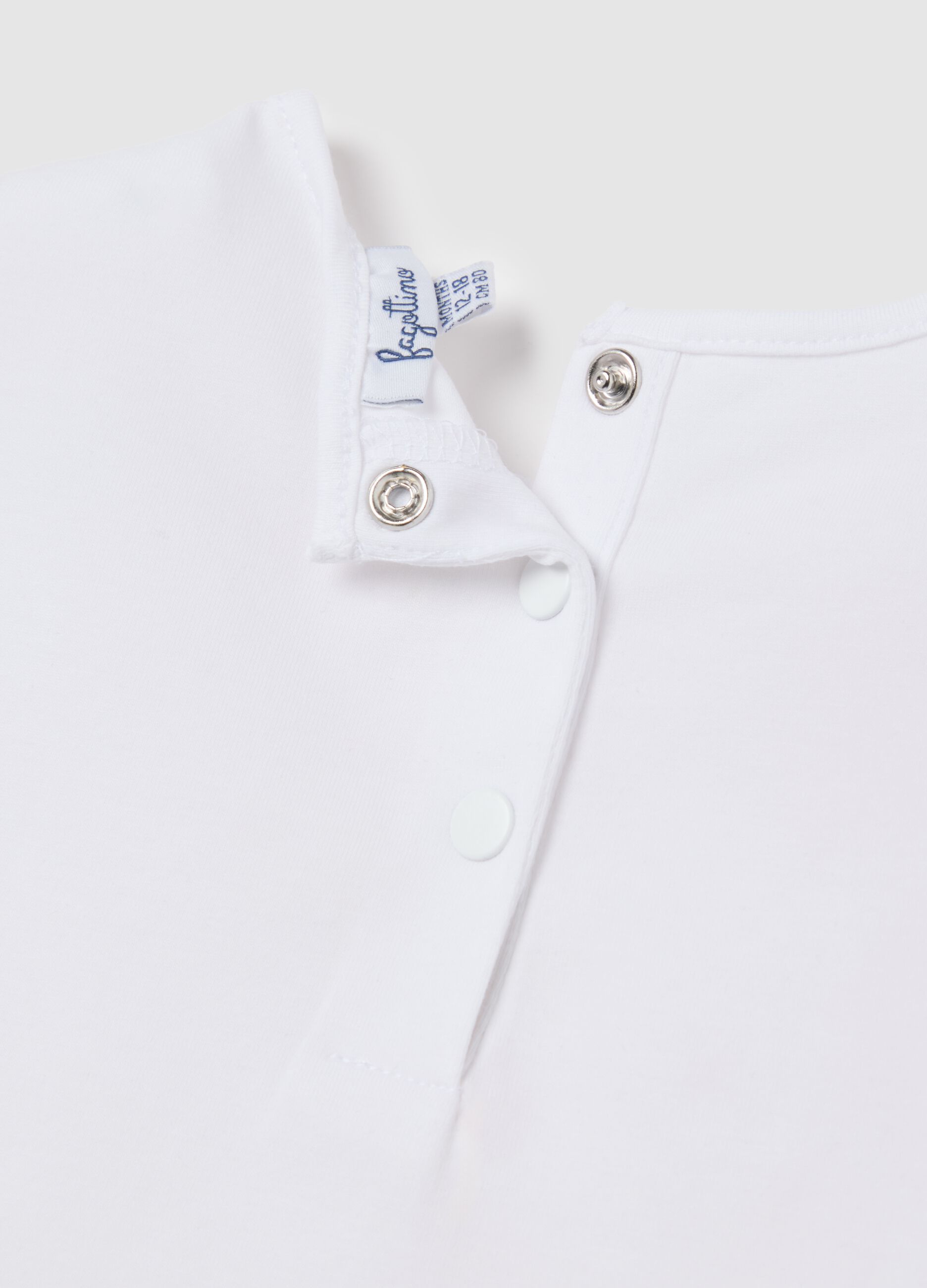 White short-sleeve t-shirt with ruffles and colourful flowers