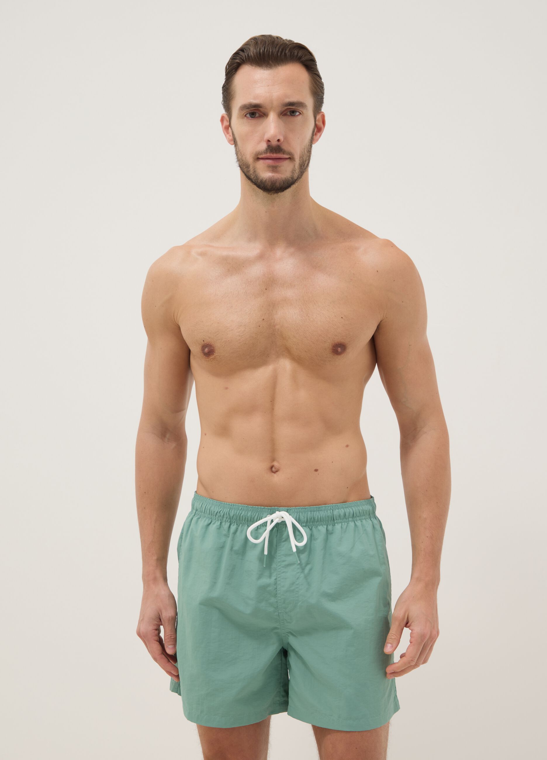 Green swim shorts with elasticated waistband