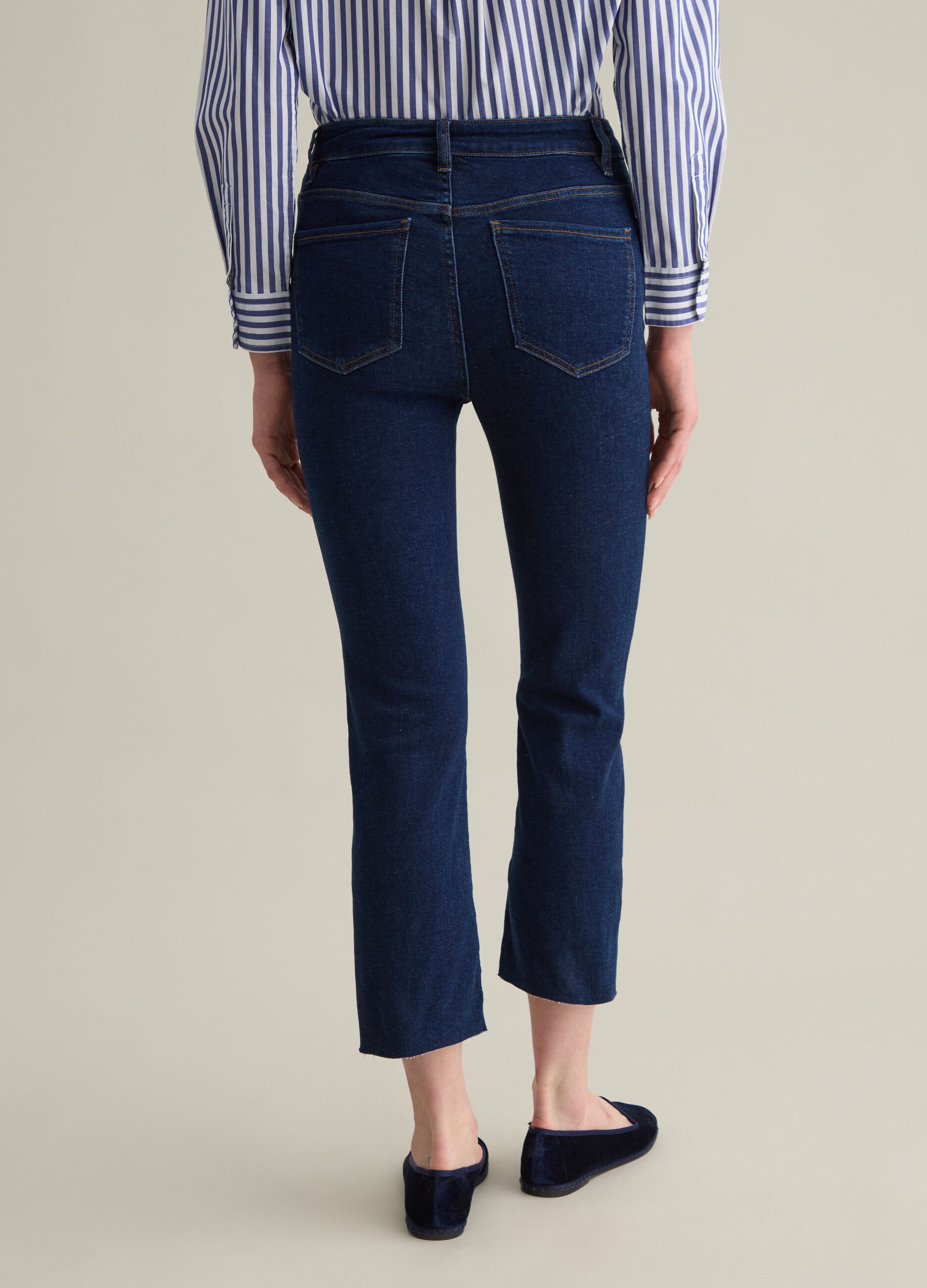 Cropped blue flare-fit jeans with raw edging