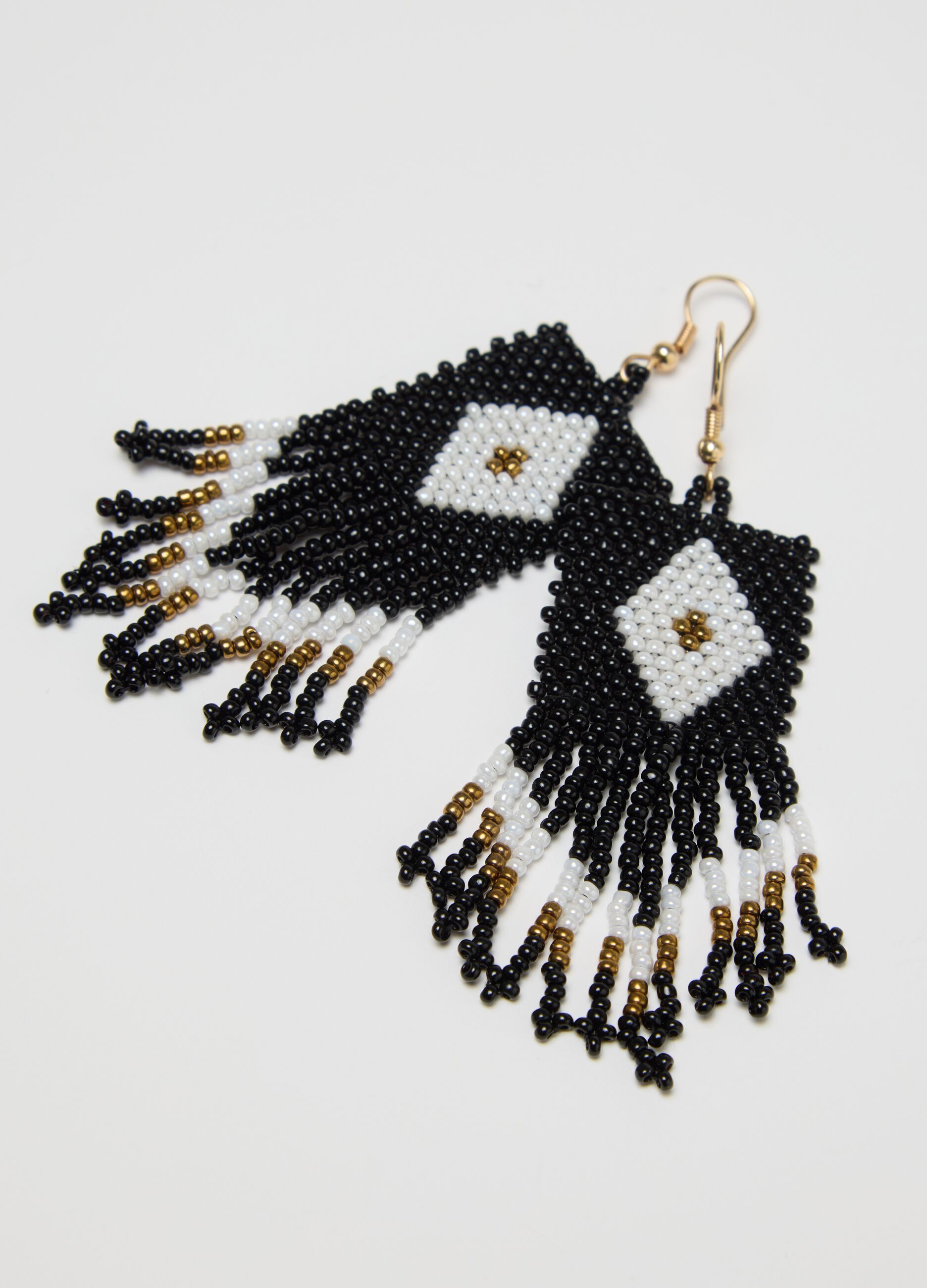 Black and white pendant earrings with beads and fringing