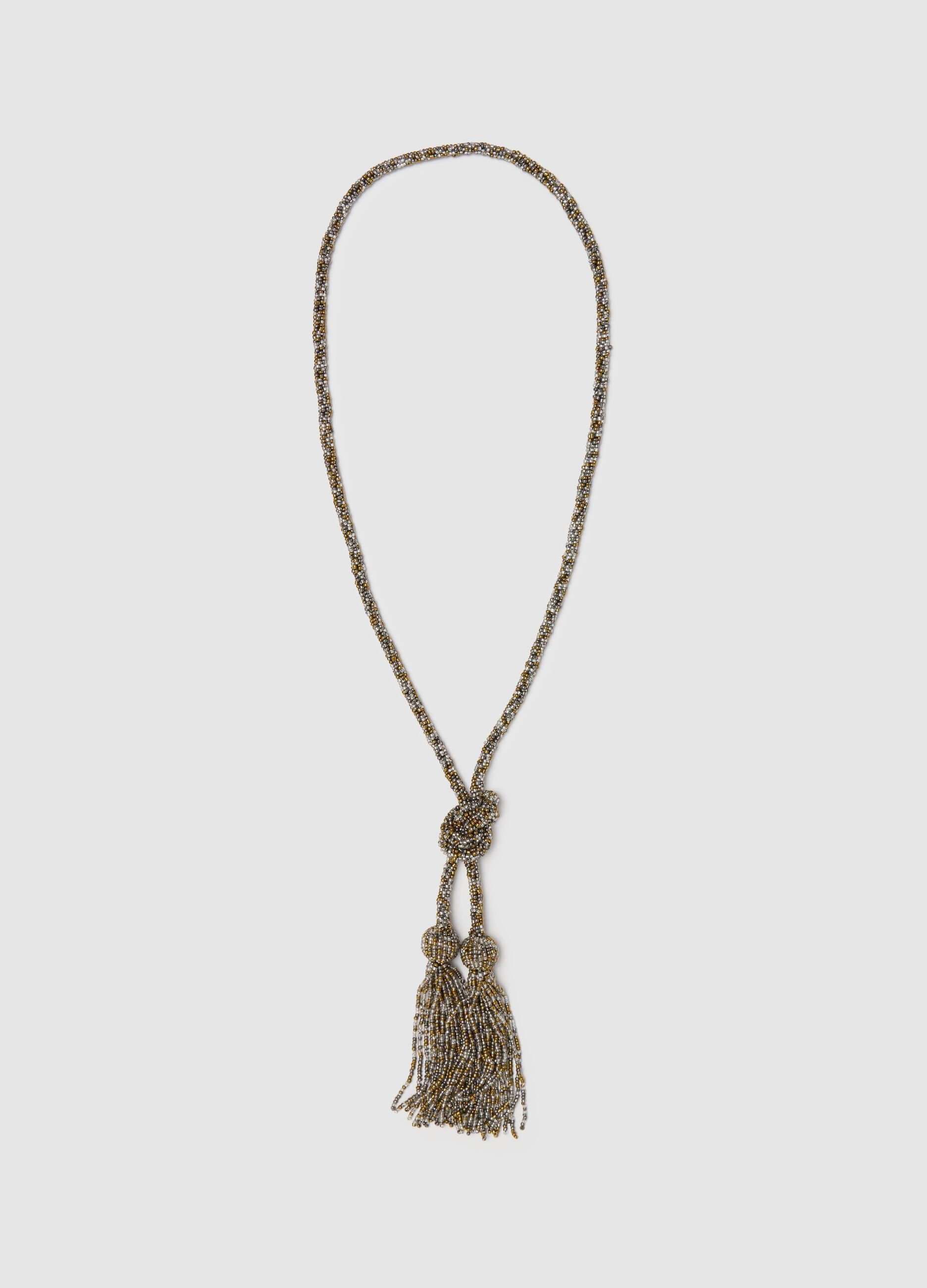 Collana lunga grigio e oro con perline e nappine