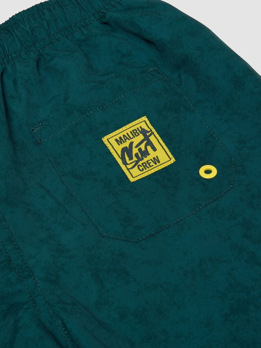 Green swim shorts with graphic print_3