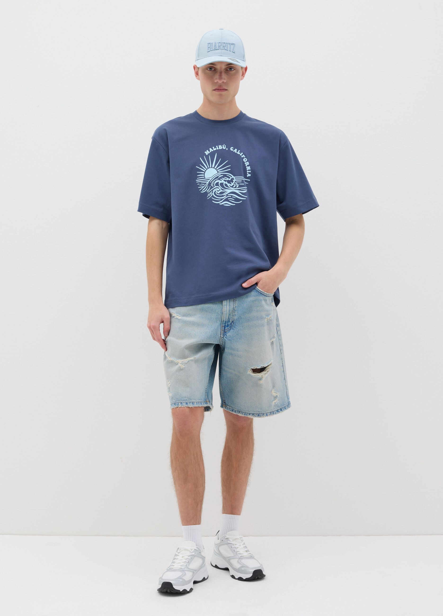 Blue denim shorts with ripped details