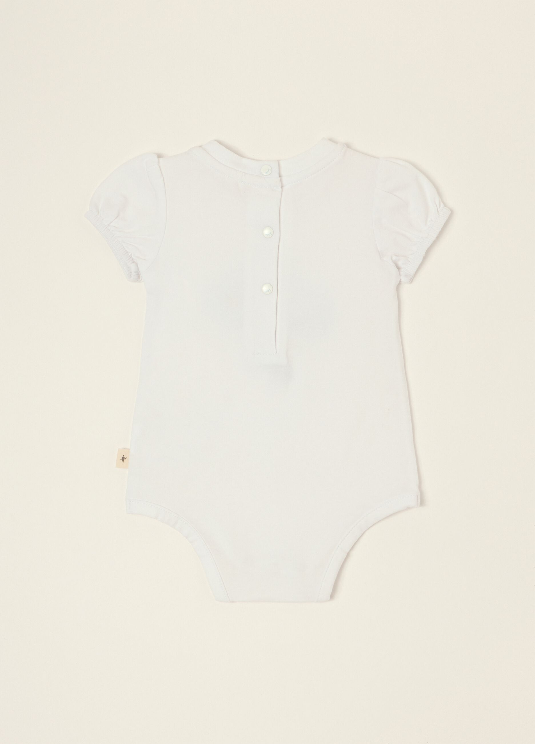 White baby girl bodysuit with floral details in stretch cotton