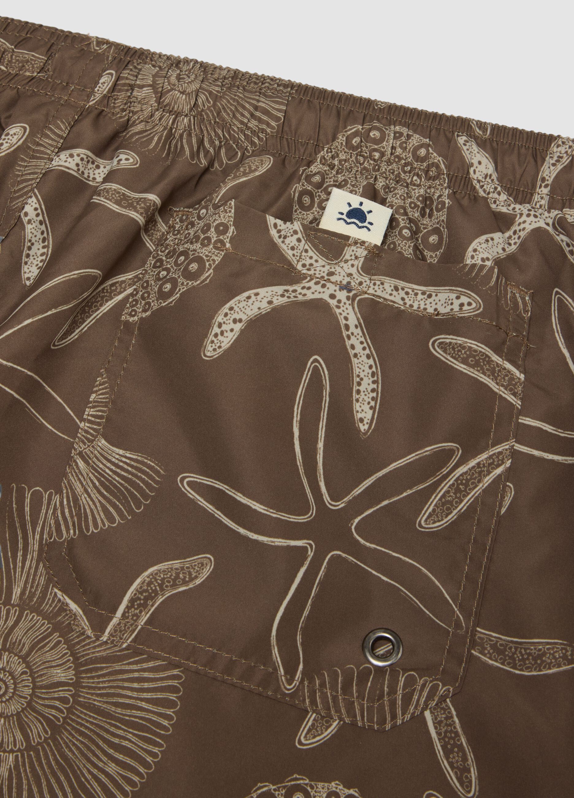 Brown swim shorts with seashell and starfish print