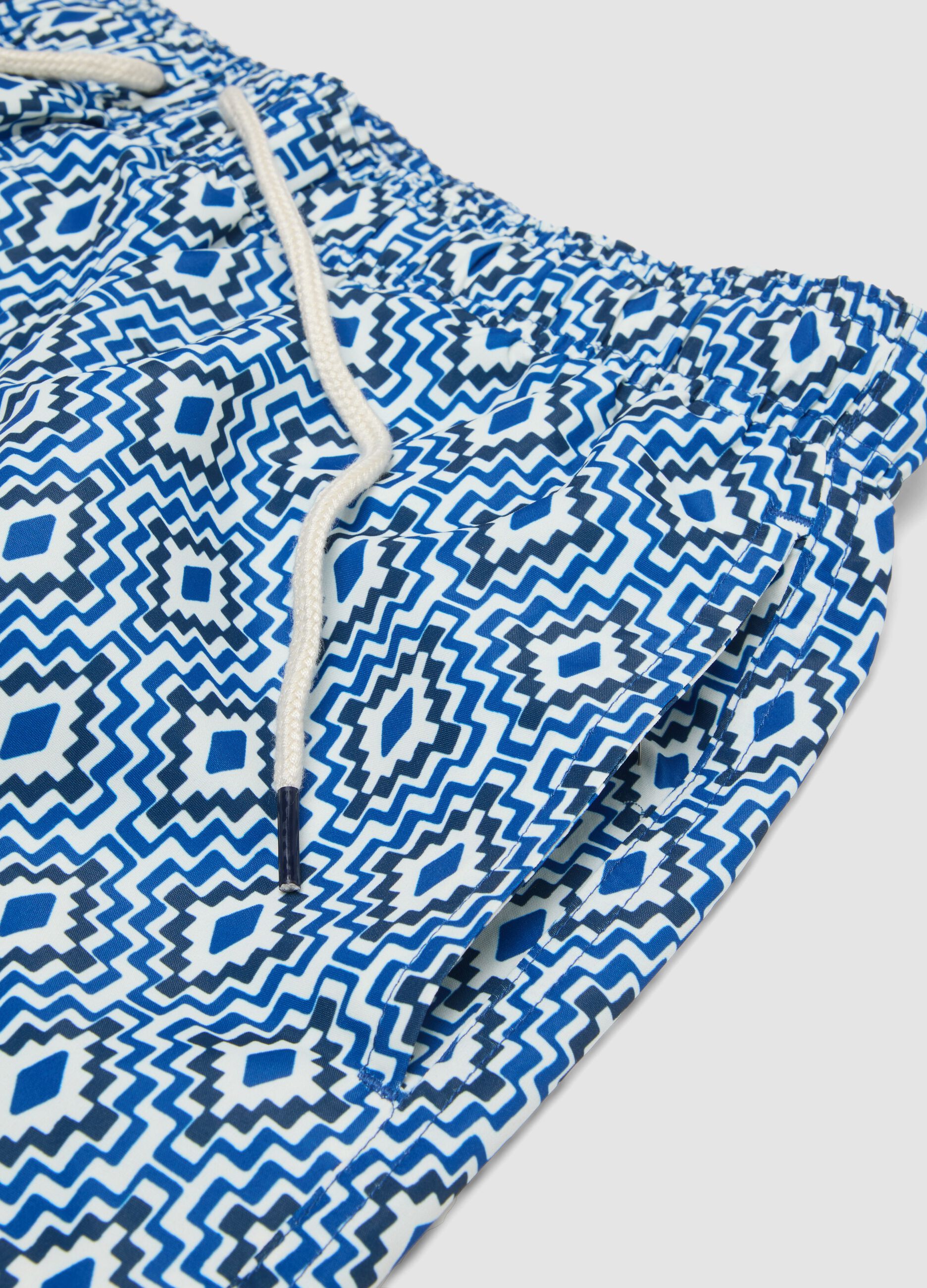 Blue swim shorts with geometric print