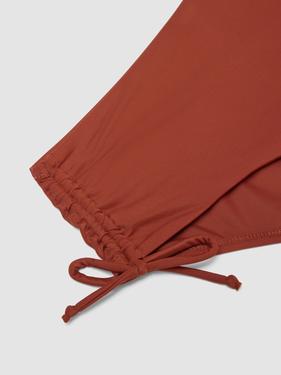 Orange stretch bikini bottoms with ruched side detailing_1