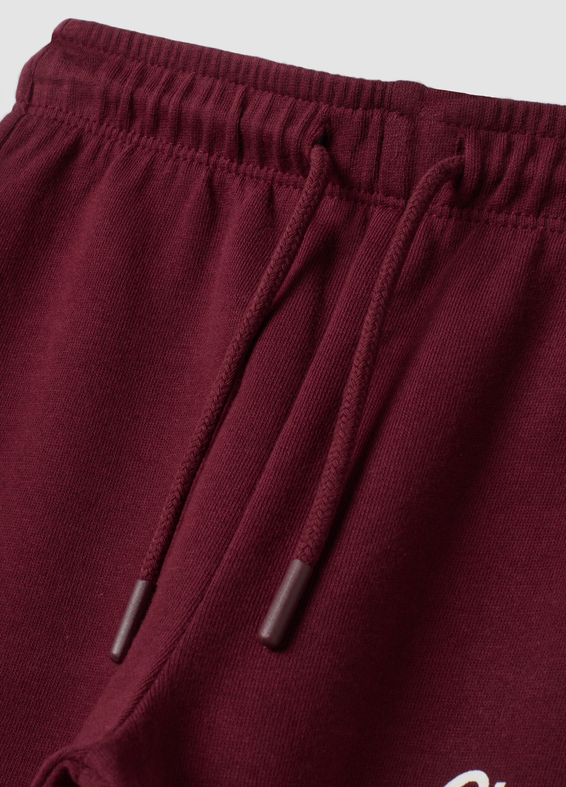 Pantaloni jogger rossi in puro cotone con stampa
