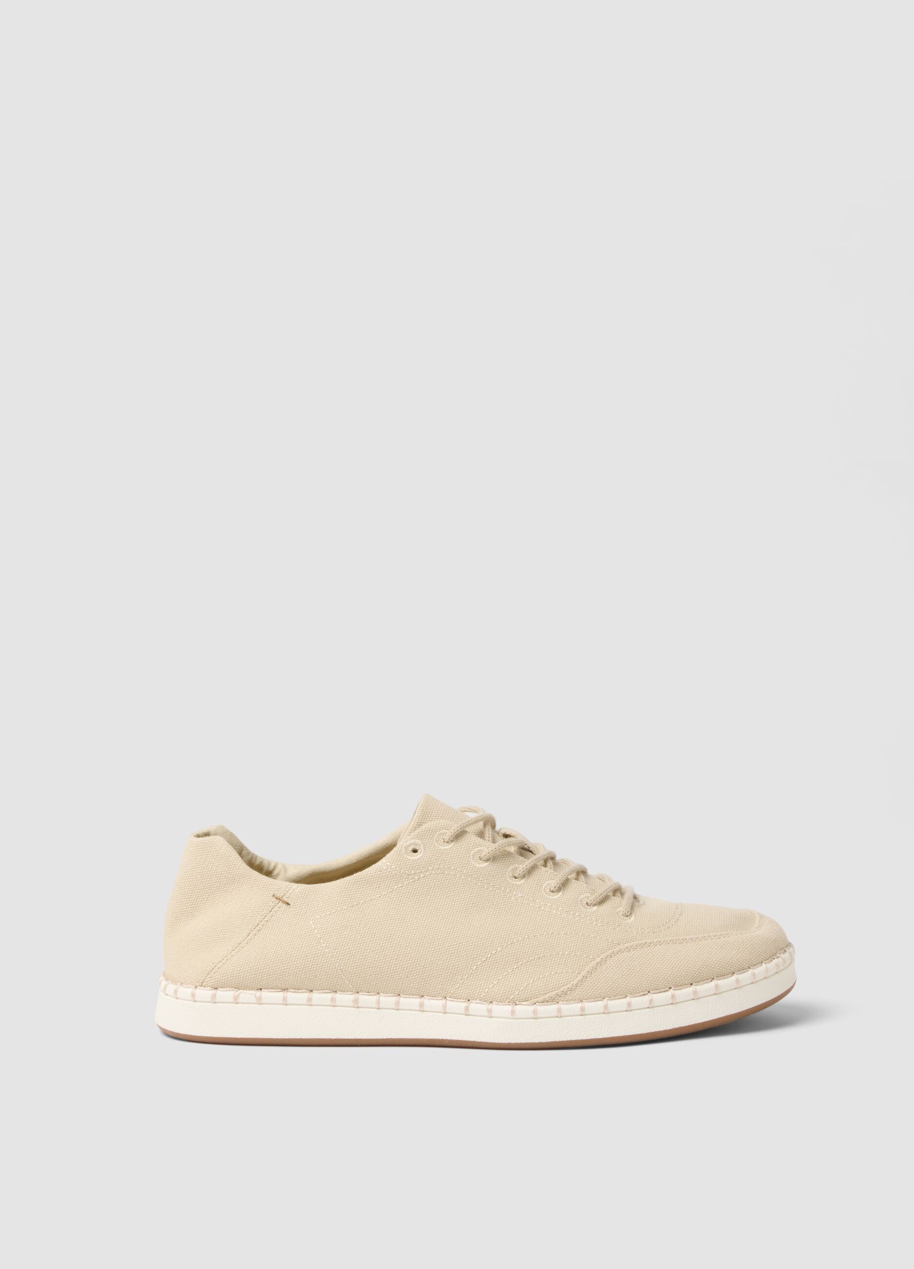 Beige lace-up trainers with visible stitching