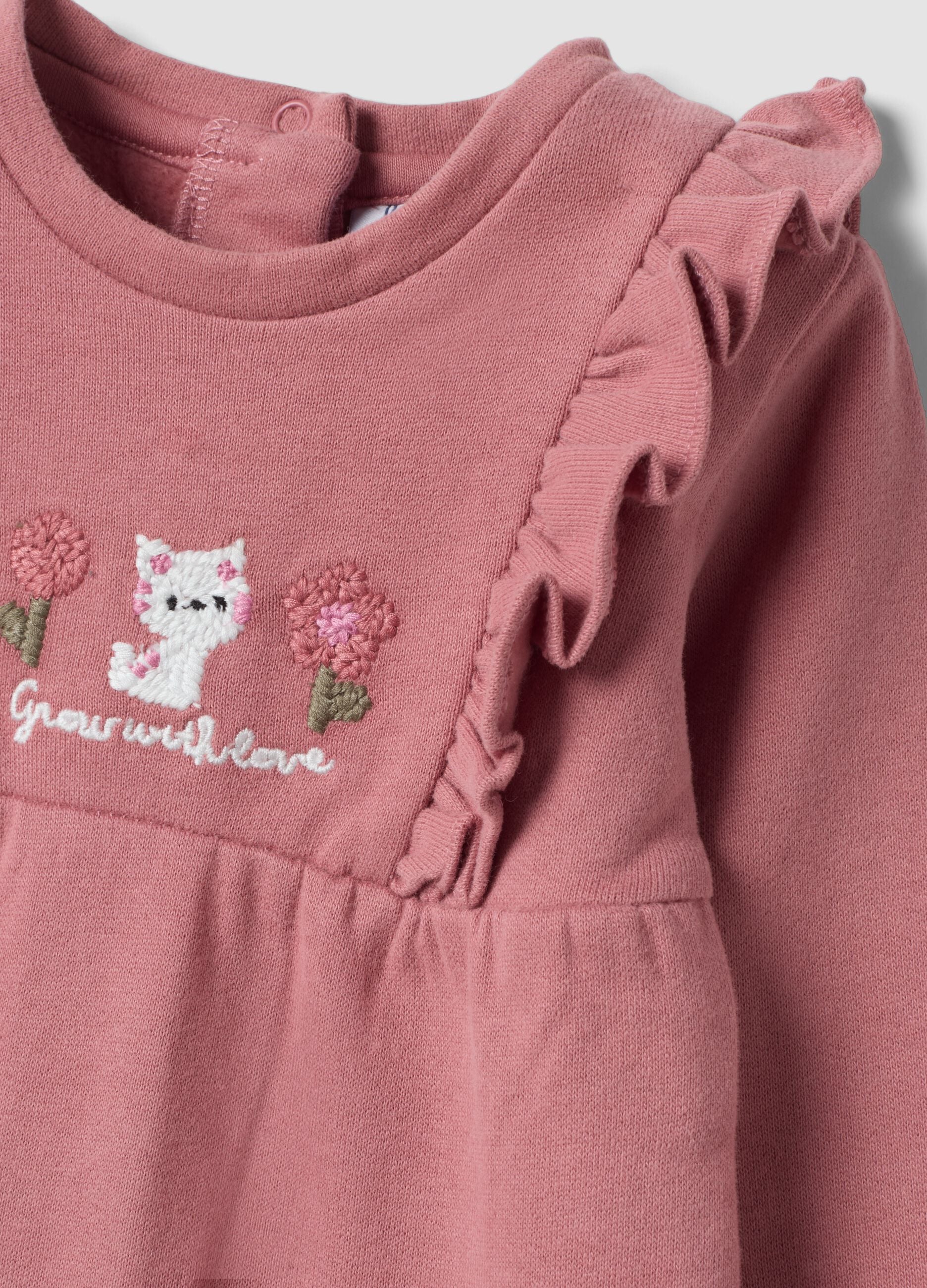 Pink organic cotton sleepsuit with ruffles and chest embroidery
