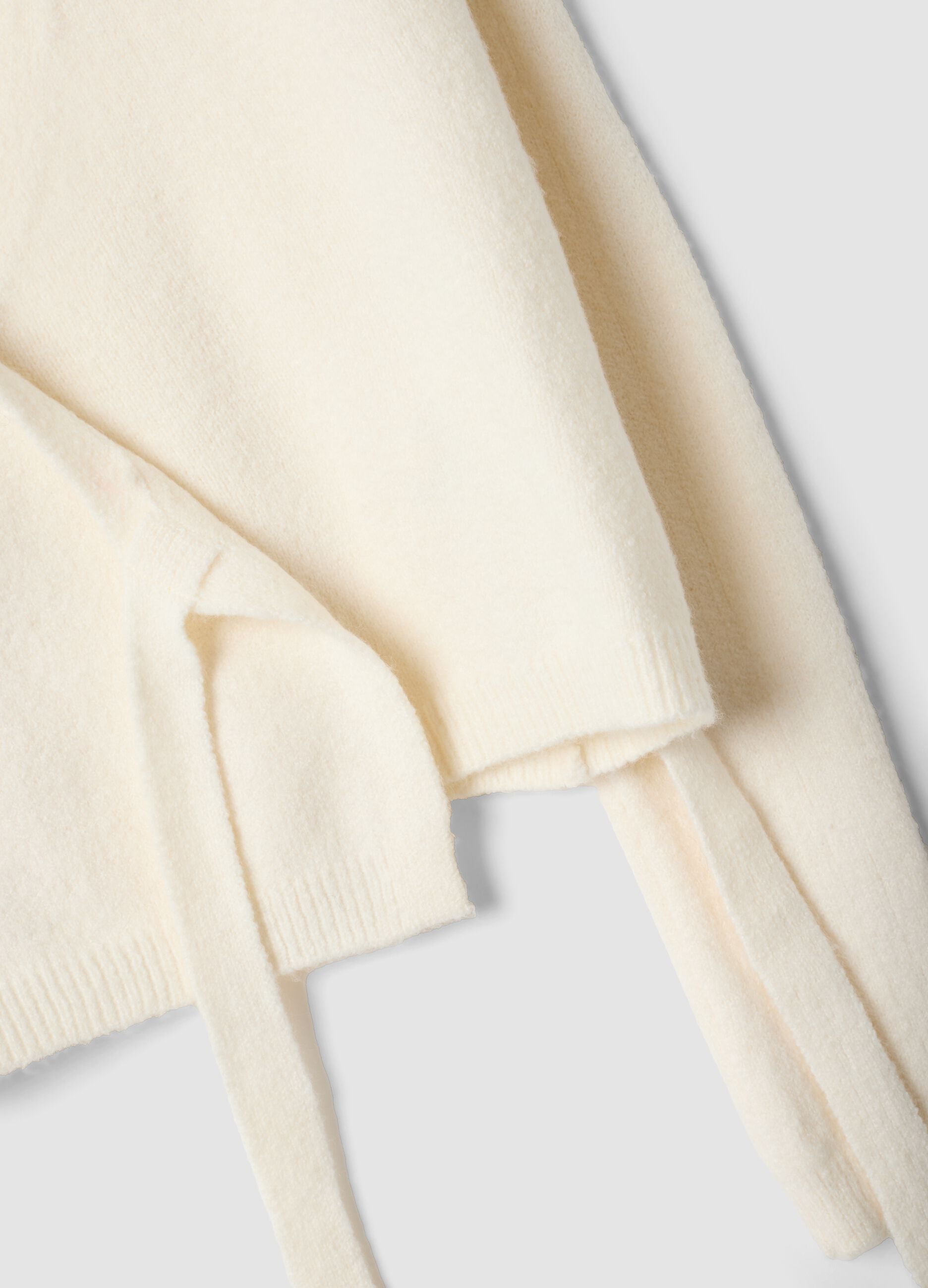 White wrap cardigan with deep V-neckline