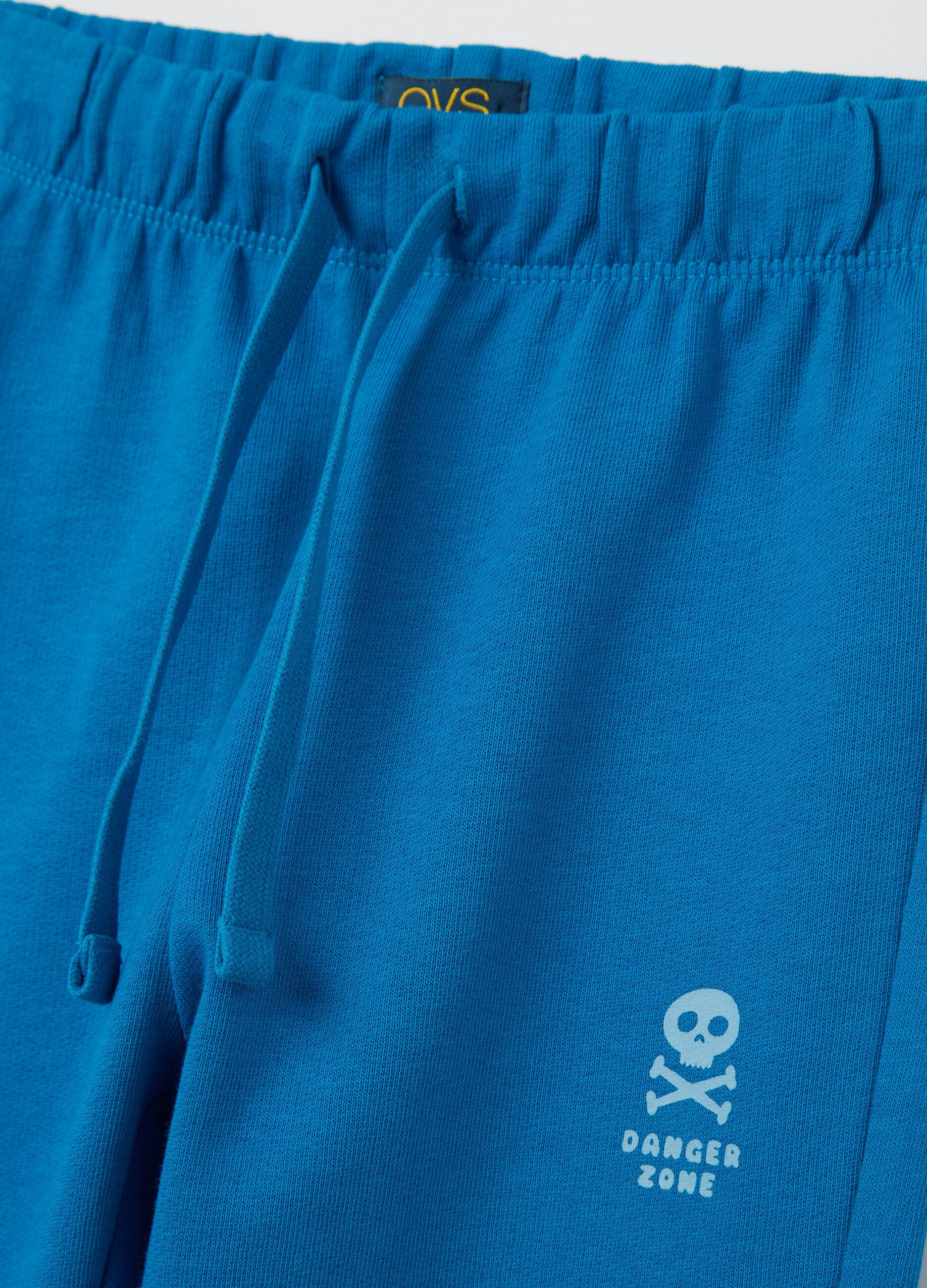 Light blue cotton joggers with drawstring and print