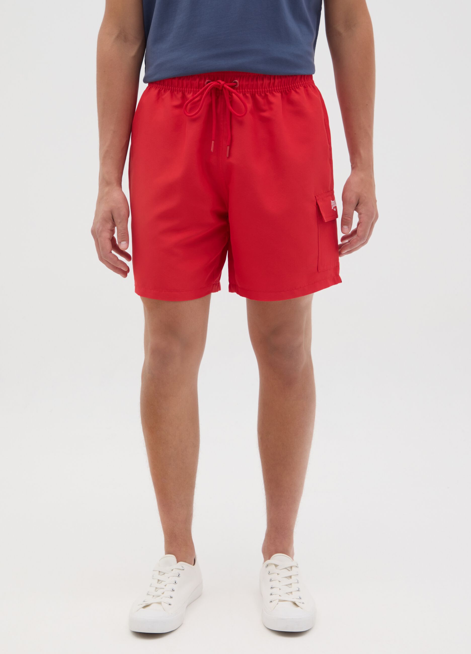 Red swimming trunks with logo print