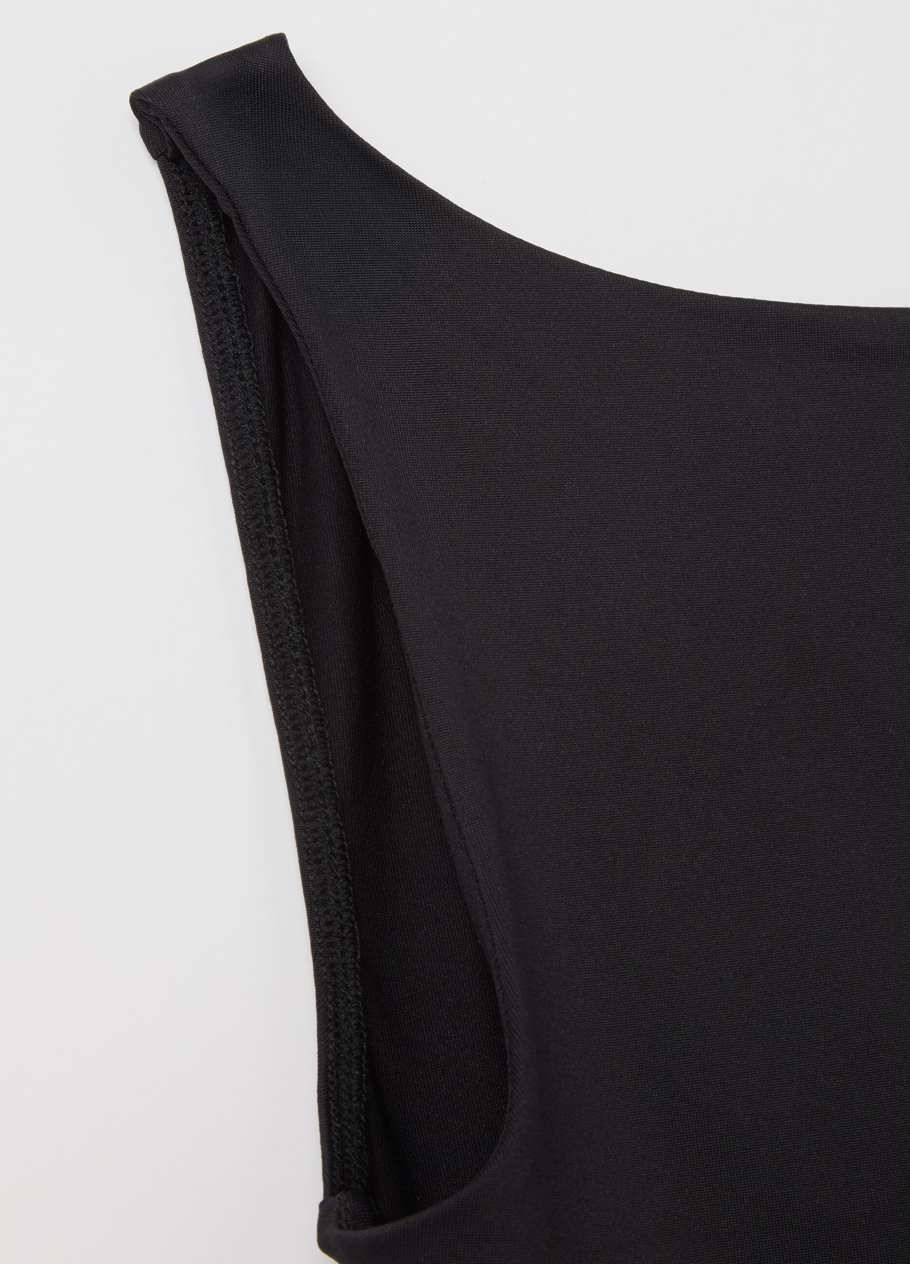 Women’s fitted top in black stretch fabric with wide straps