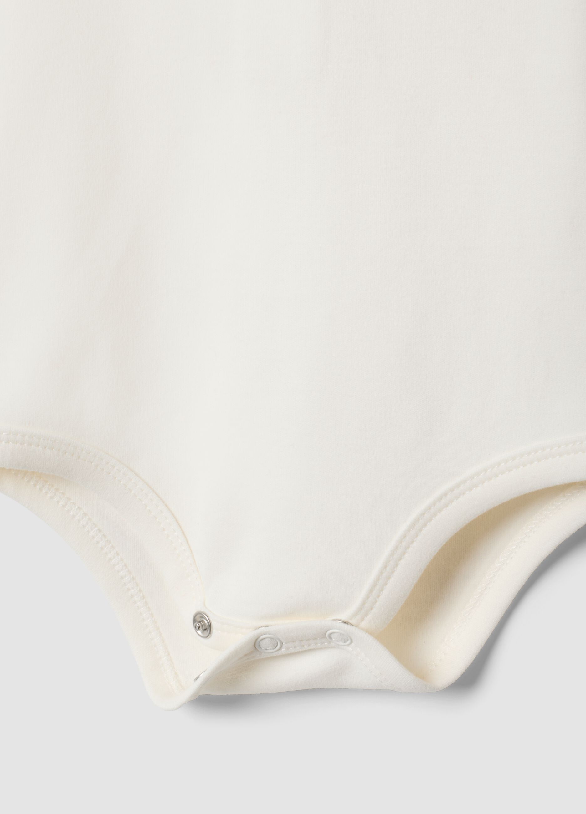 Body bianco in puro cotone organico con colletto ricamato per neonata