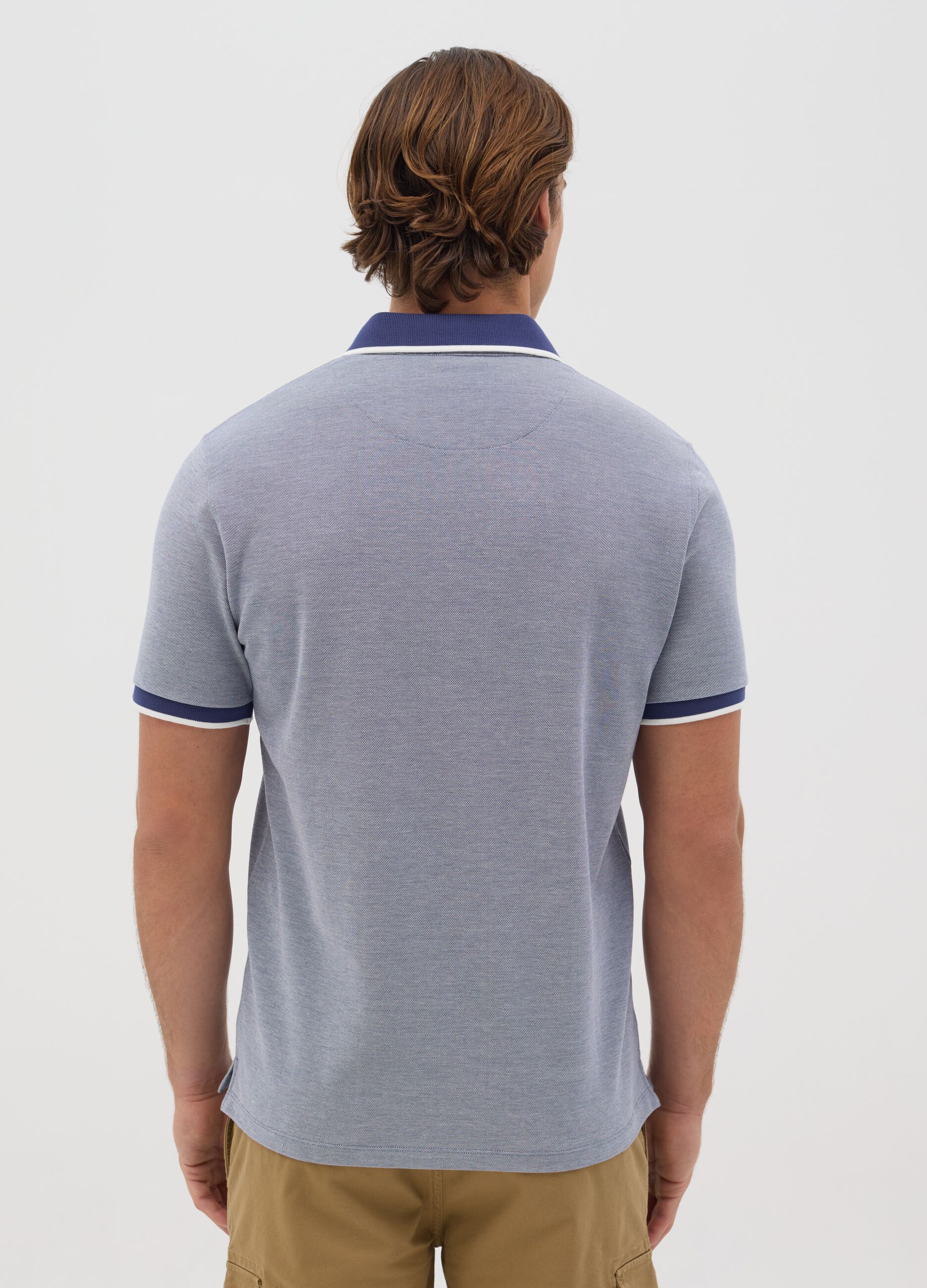 Blue polo shirt with short sleeves in cotton piquet