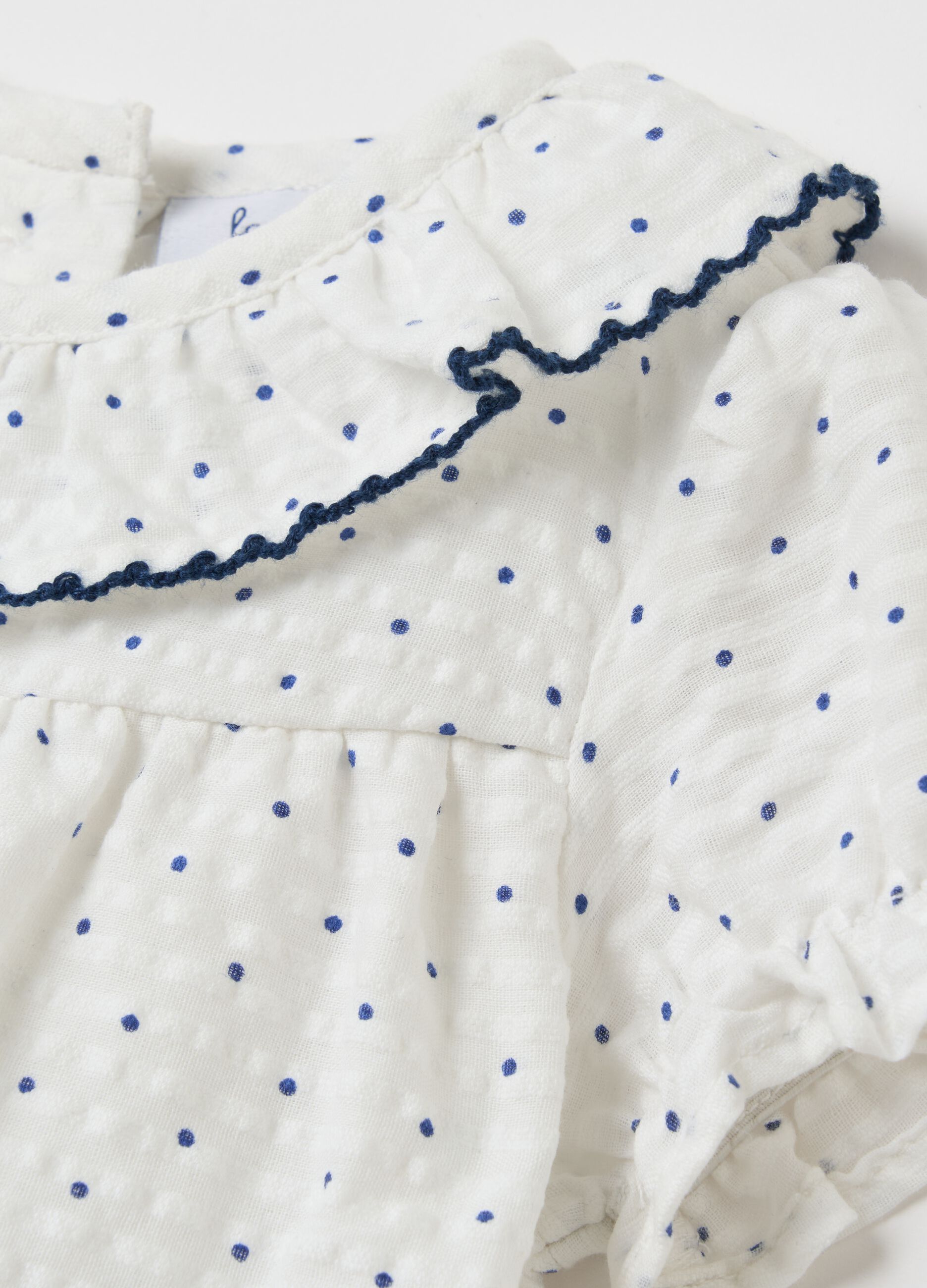 Romper suit with striped motif polka dot pattern