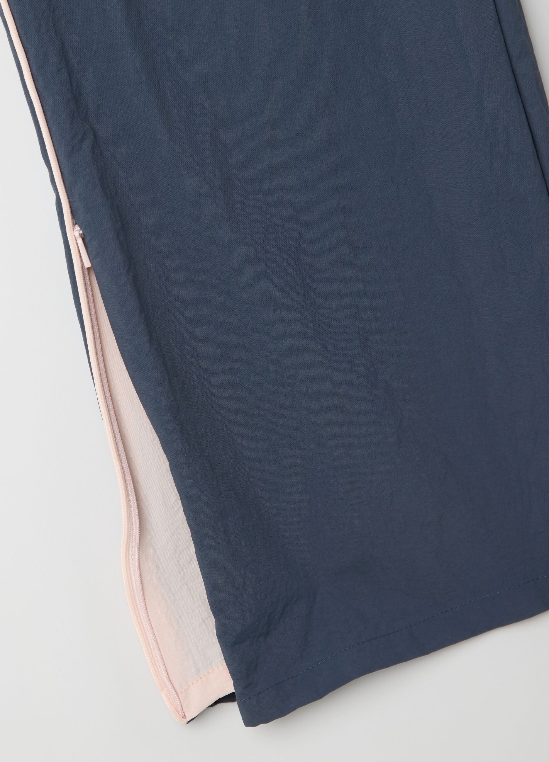 Navy blue nylon joggers with splits and zip