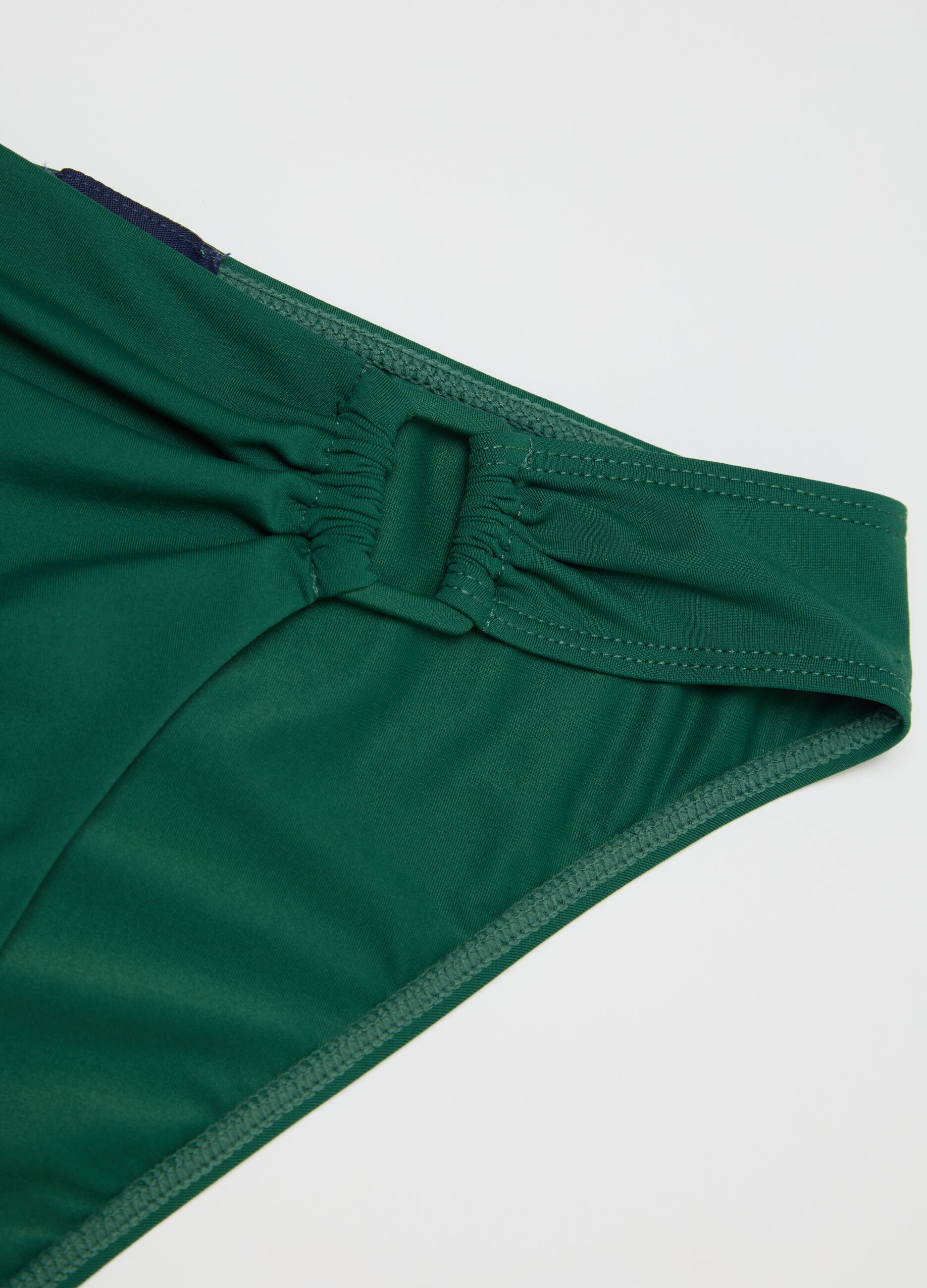 Women’s briefs in green stretch fabric with bow detail